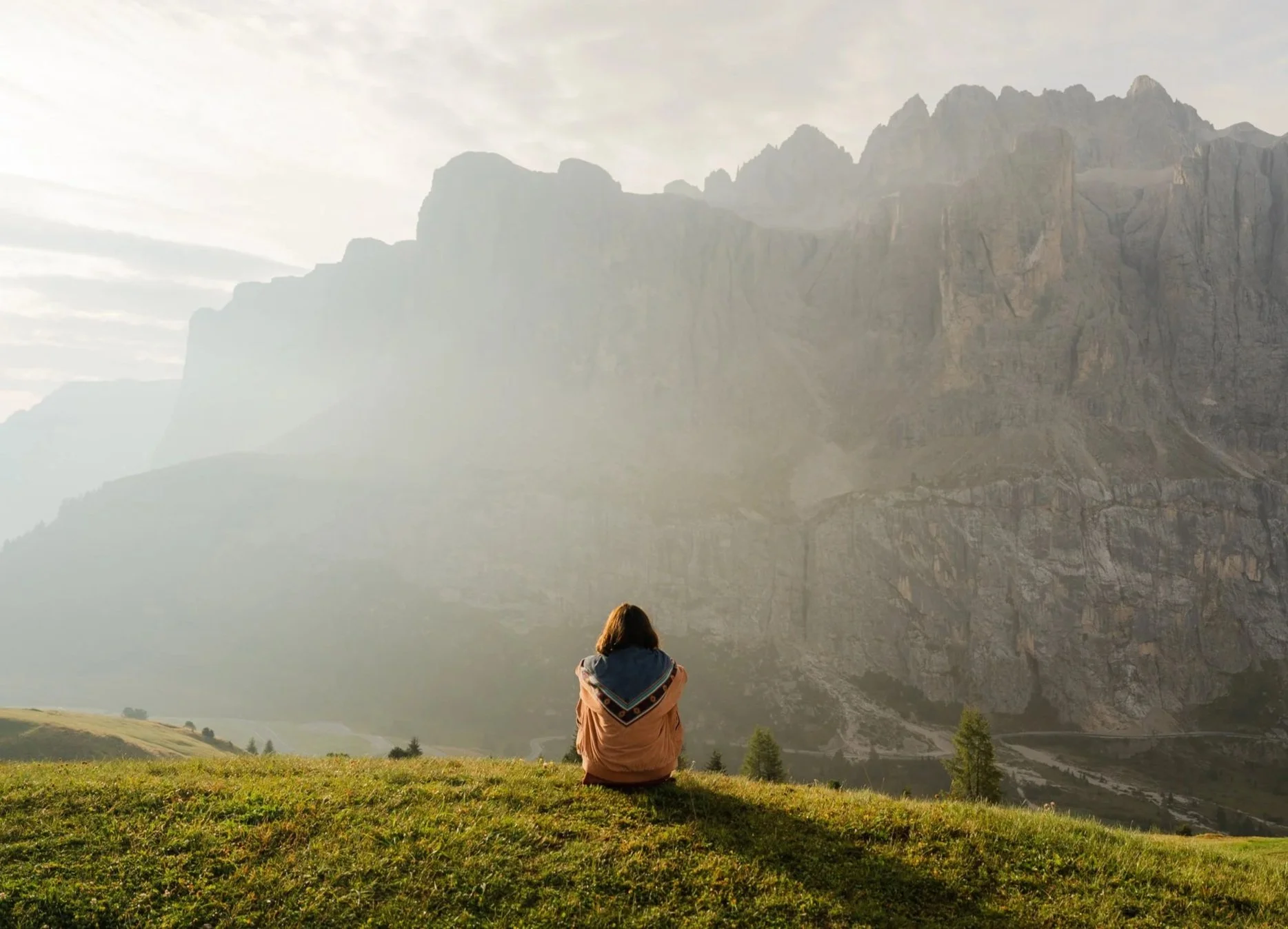 Woman sitting quietly overlooking dramatic mountain landscape — therapy for adolescents and adults at EMDR Resource Center Portland Oregon