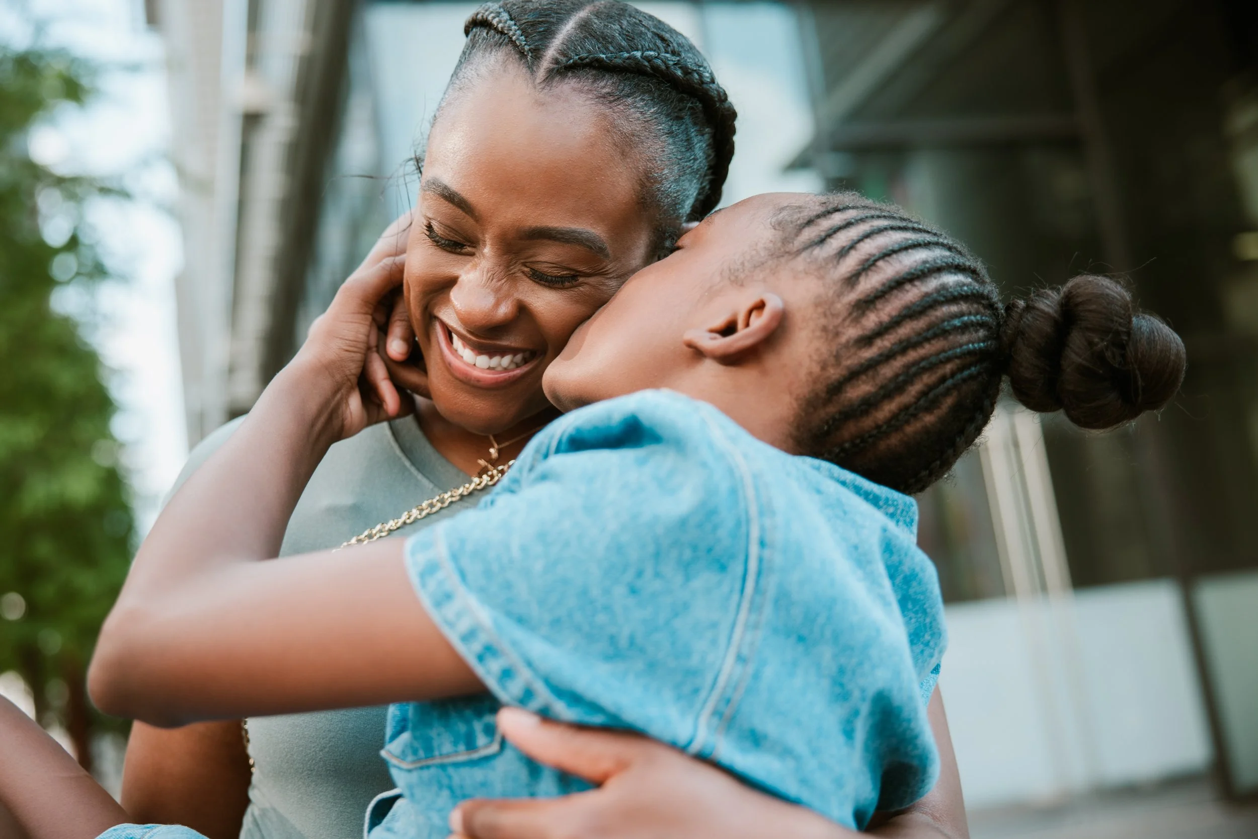 Black mother embracing young child — parent support therapy for stress and connection at EMDR Resource Center Portland Oregon