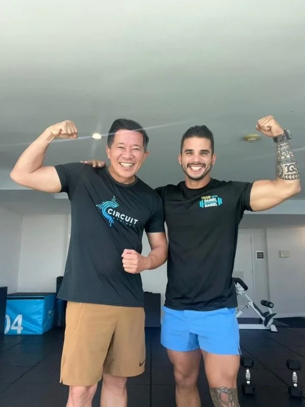 A picture of Daniel Daniel, Certified Personal Trainer, with one of his clients at a gym in Miami. 
