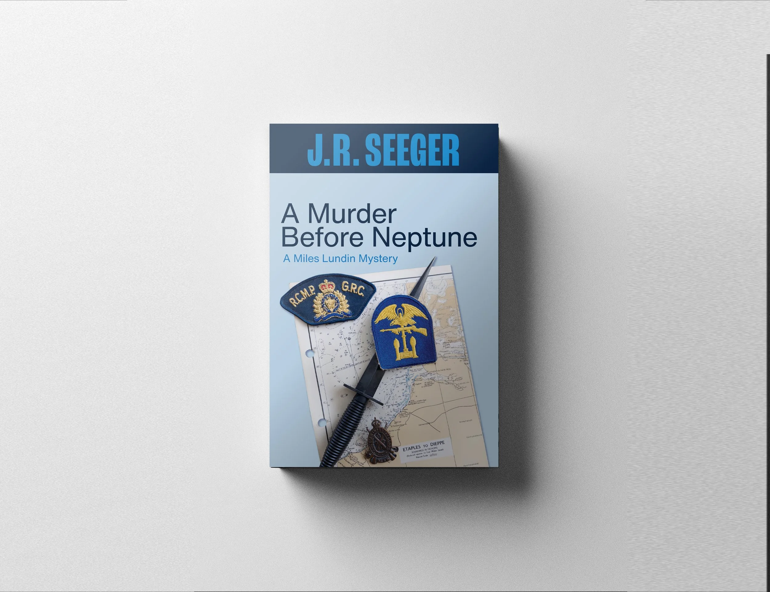 A book titled 'A Murder Before Neptune' by J.R. Seeger, with police badges, a map, a compass, and a black pen placed on top.
