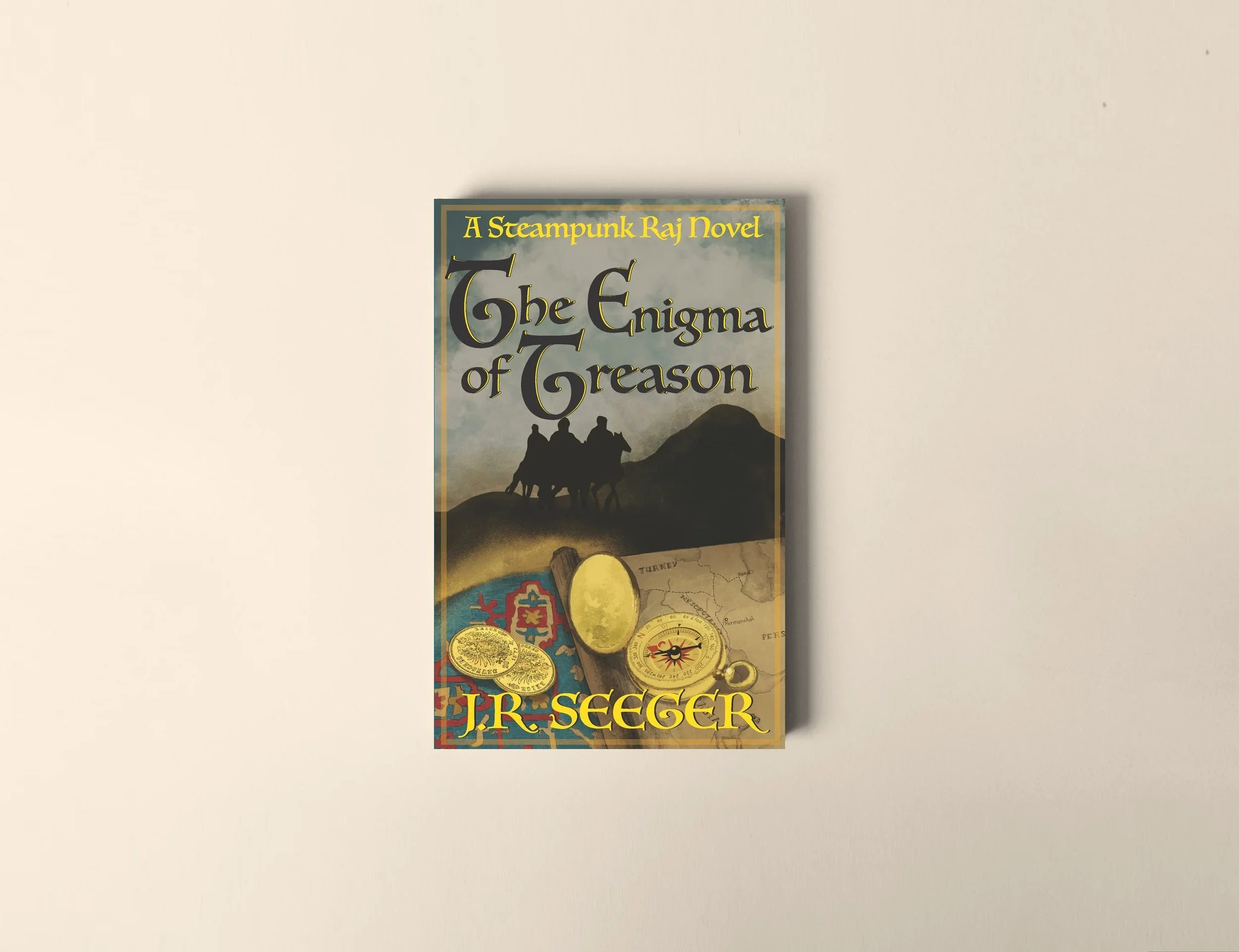 Book titled 'The Enigma of Greason' by J.R. Segger, featuring a illustration of three people riding horses against a mountainous landscape, with images of coins and a compass at the bottom.