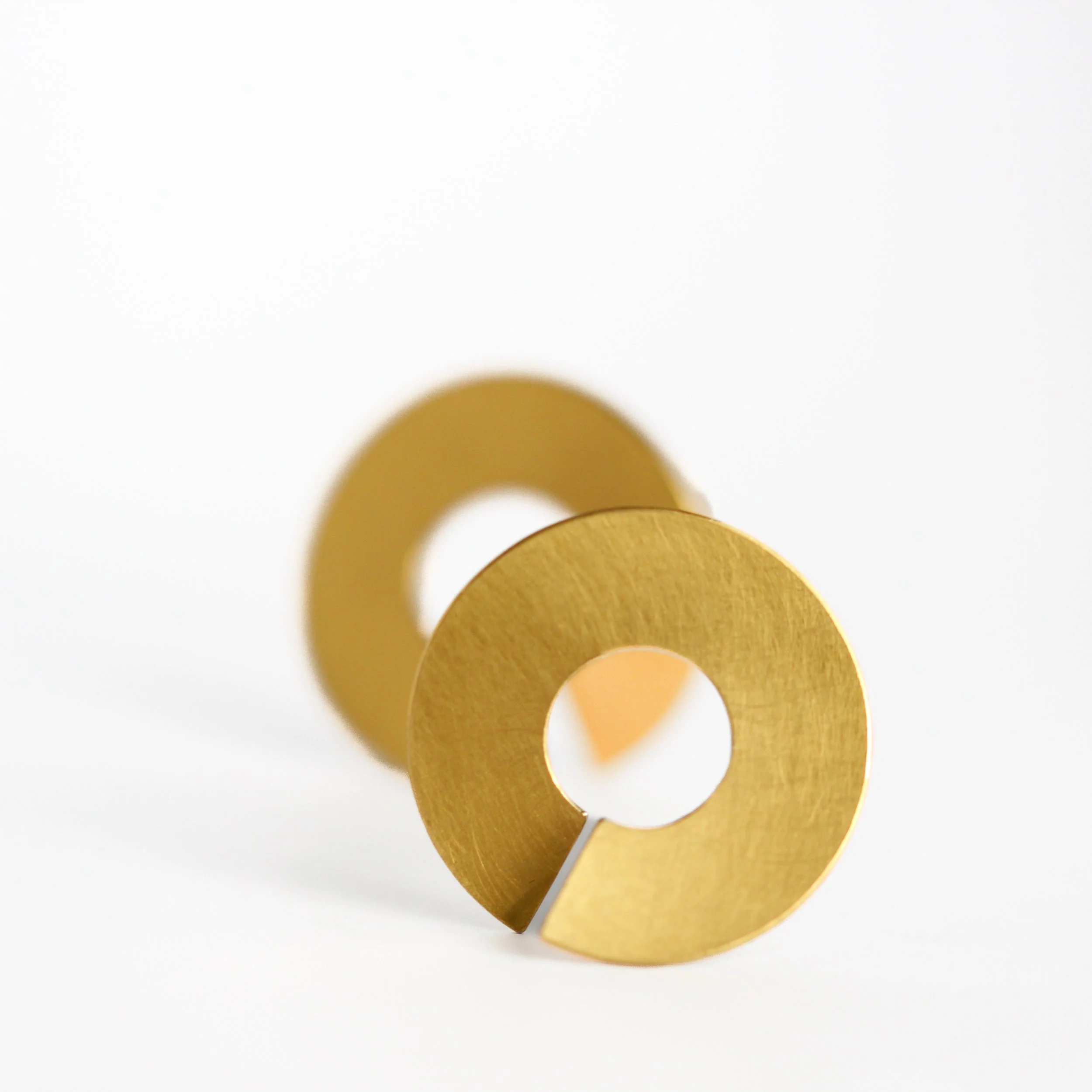 Close-up view of gold coins arranged in an arc on a white background.