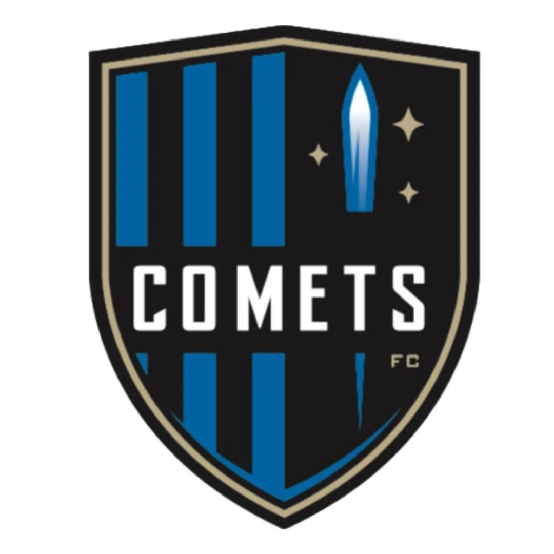 Logo for the Comets FC featuring a black shield with blue vertical stripes, a stylized comet in the shape of a sword, and stars, with the word 'COMETS' in white.