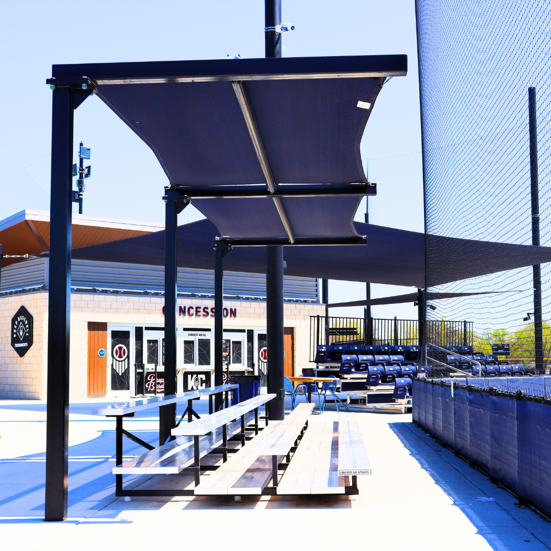 Cantilever shade structure over bleacher seating at HomeField KC baseball complex in Kansas City