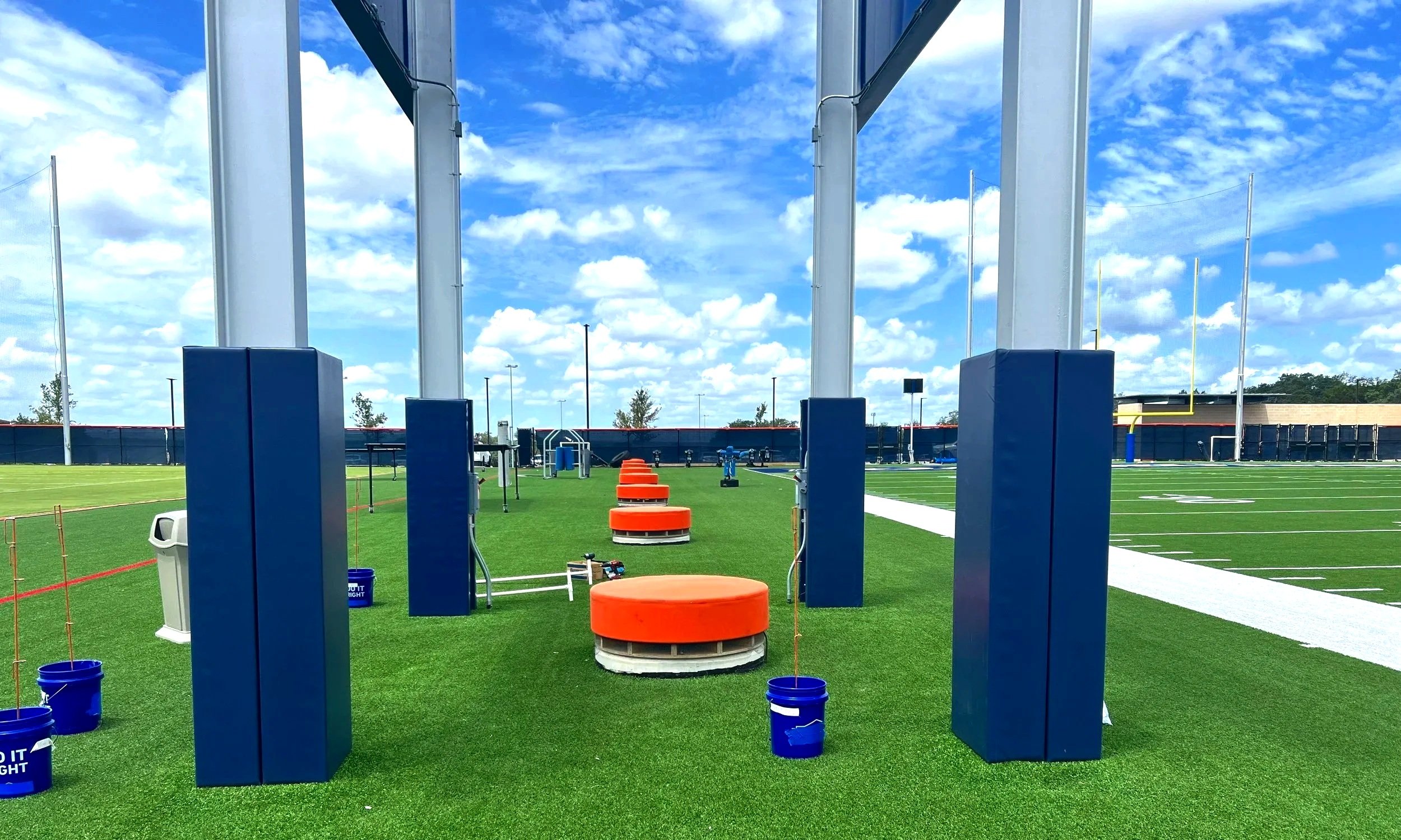 Padded support columns and athletic turf at Dallas Cowboys Training Center professional football facility