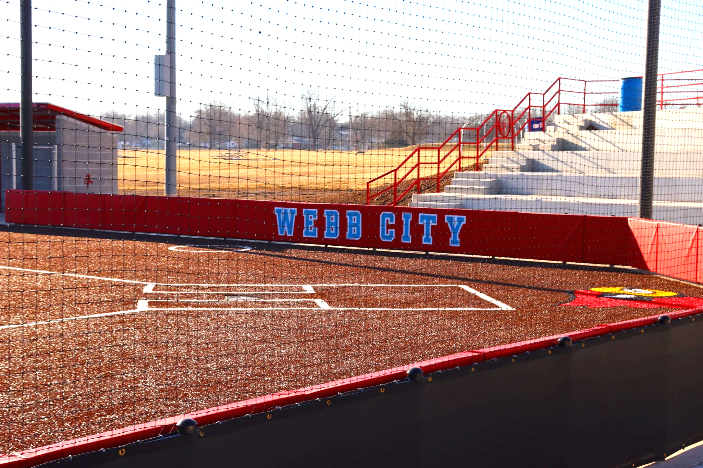 Your outfield wall padding is a safety requirement. Your program's identity is a competitive advantage. USS custom branded wall padding delivers both at the same time — as seen here at Webb City where the field announces the program before the first 