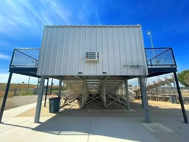 The full exterior view of the USS press box at Waverly High School in Waverly, Nebraska — an 8x18 foot professional press box with HVAC and electrical already included, elevated above the grandstand and built to perform in every season. One structure