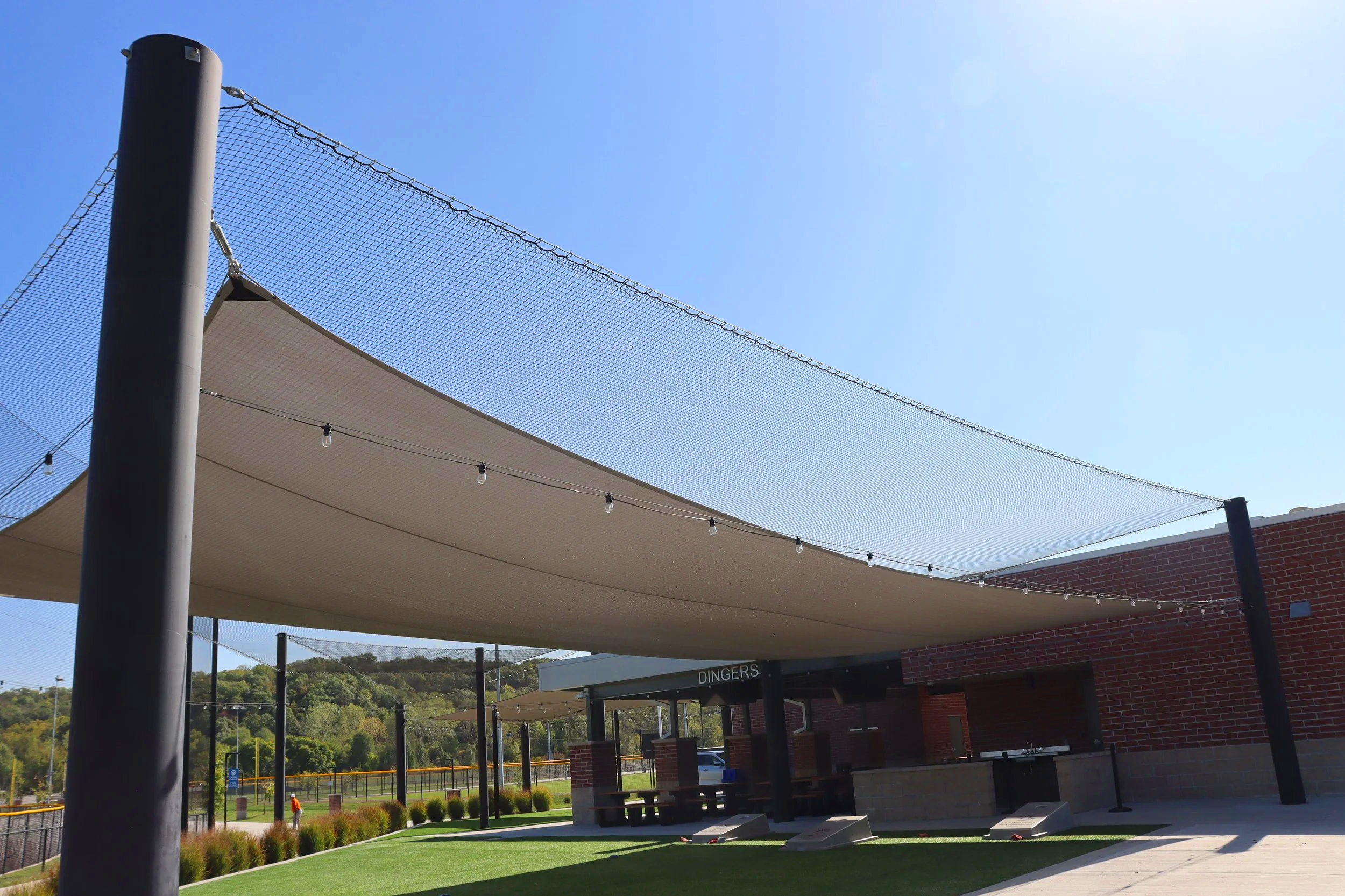 Your backstop has netting. Your foul lines have netting. But what about the spaces where your players and families gather between games? USS supplies barrier netting and shade structures that work together — covering every corner of your facility fro