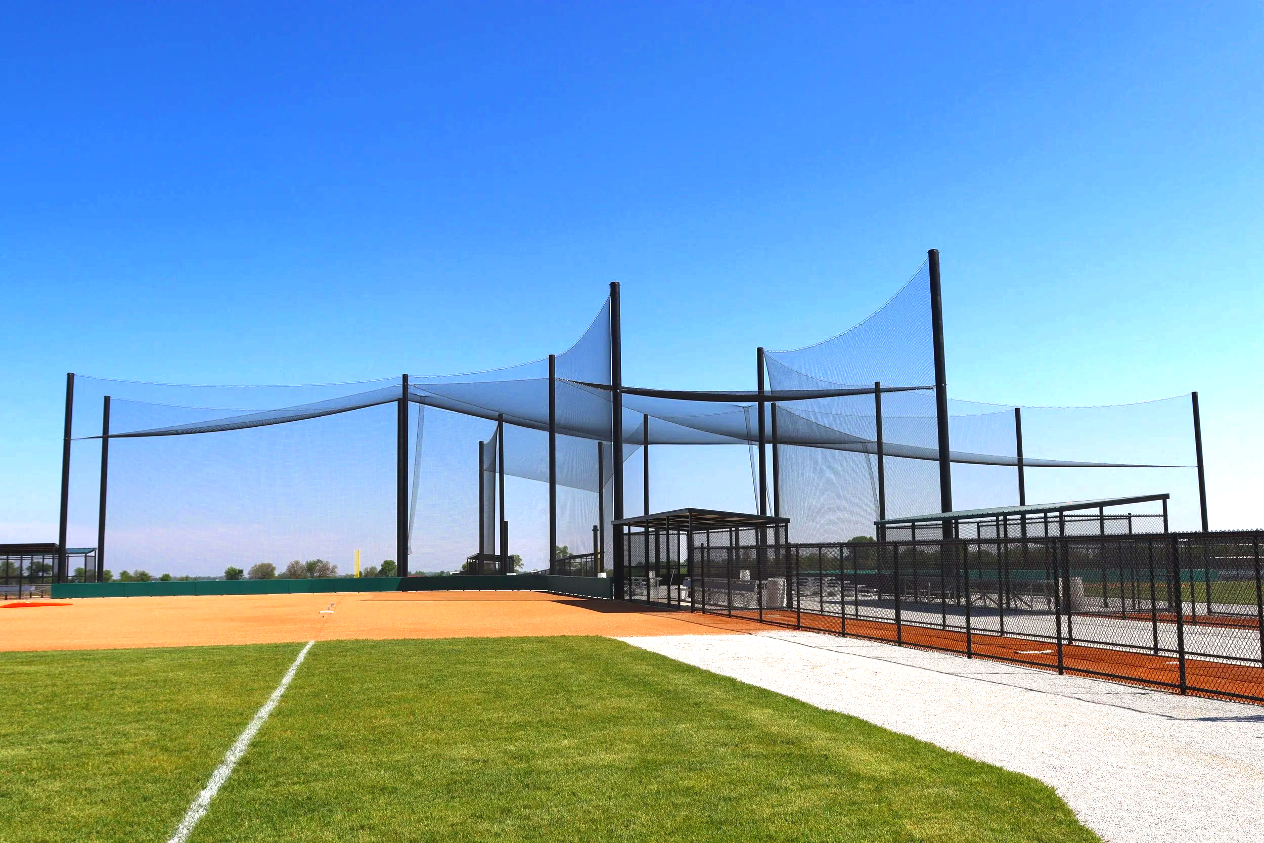 Prefabricated dugout shelter with shade roof and green turf at Elkhorn Athletic Association in Elkhorn Nebraska