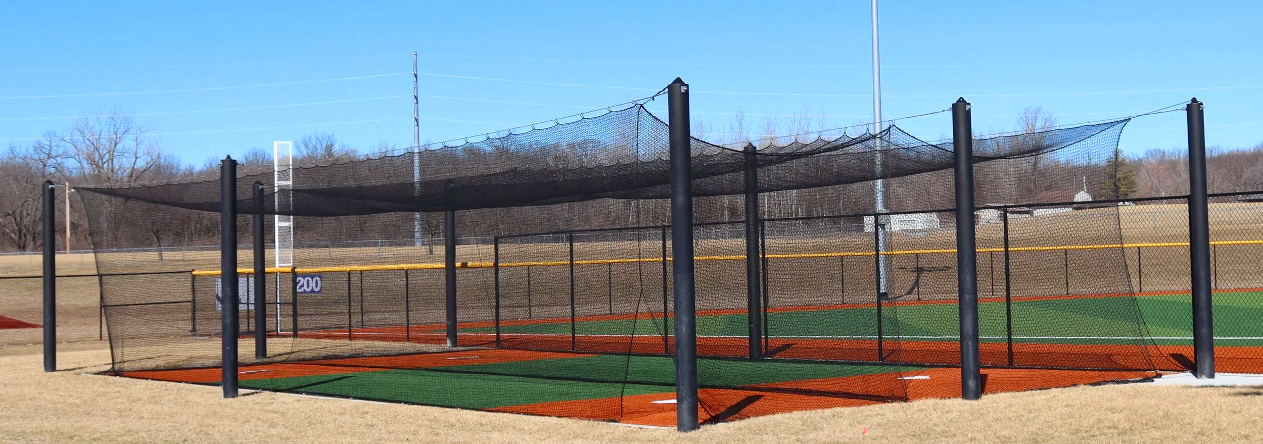 Hack Shack batting cage with professional netting at baseball training facility  Visible Caption: Hack Shack batting cage — professional netting, weather-ready construction, and a clean appearance built for serious baseball programs. Batting cages fr