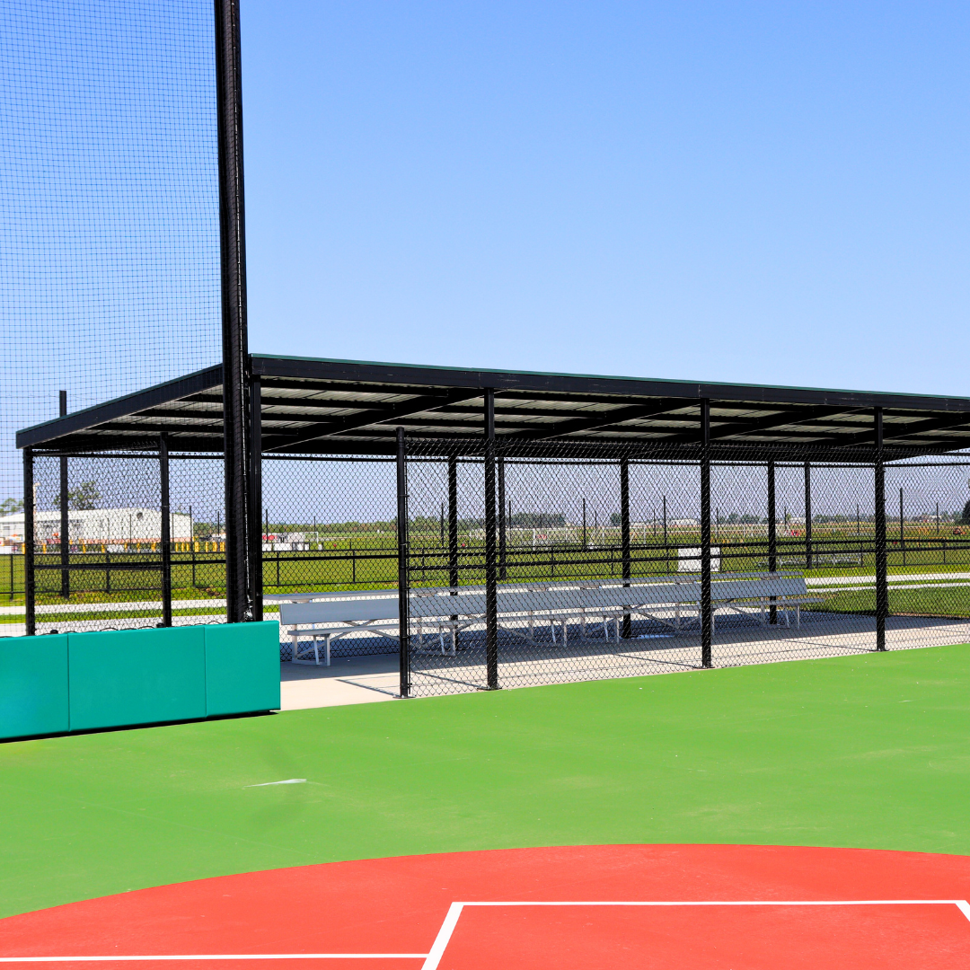 Prefabricated dugout shelter with shade roof and green turf at Elkhorn Athletic Association in Elkhorn Nebraska