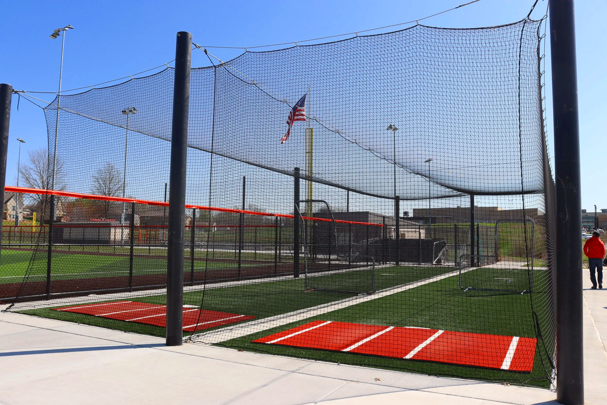 Baseball infield with turf batter's boxes and protective netting system at Bonner Springs athletic facility — USS sports field maintenance equipment and field armor panels supplier for baseball facilities