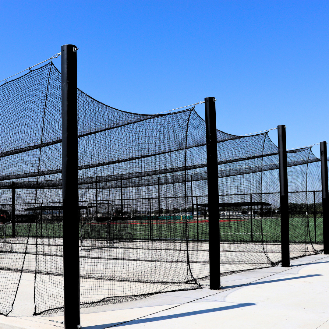 Outdoor batting cage netting system with steel frame at baseball training facility