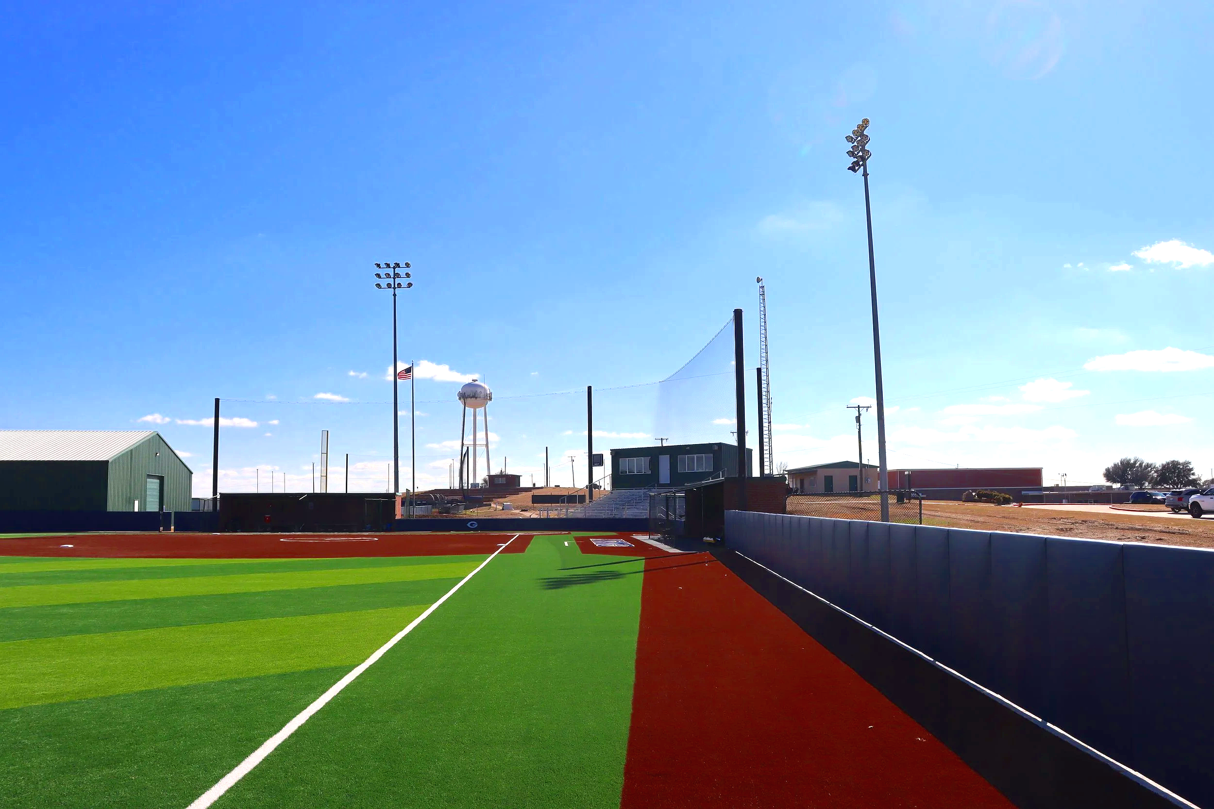 Collegiate baseball field with artificial turf and outfield wall padding at Grayson College Denison Texas