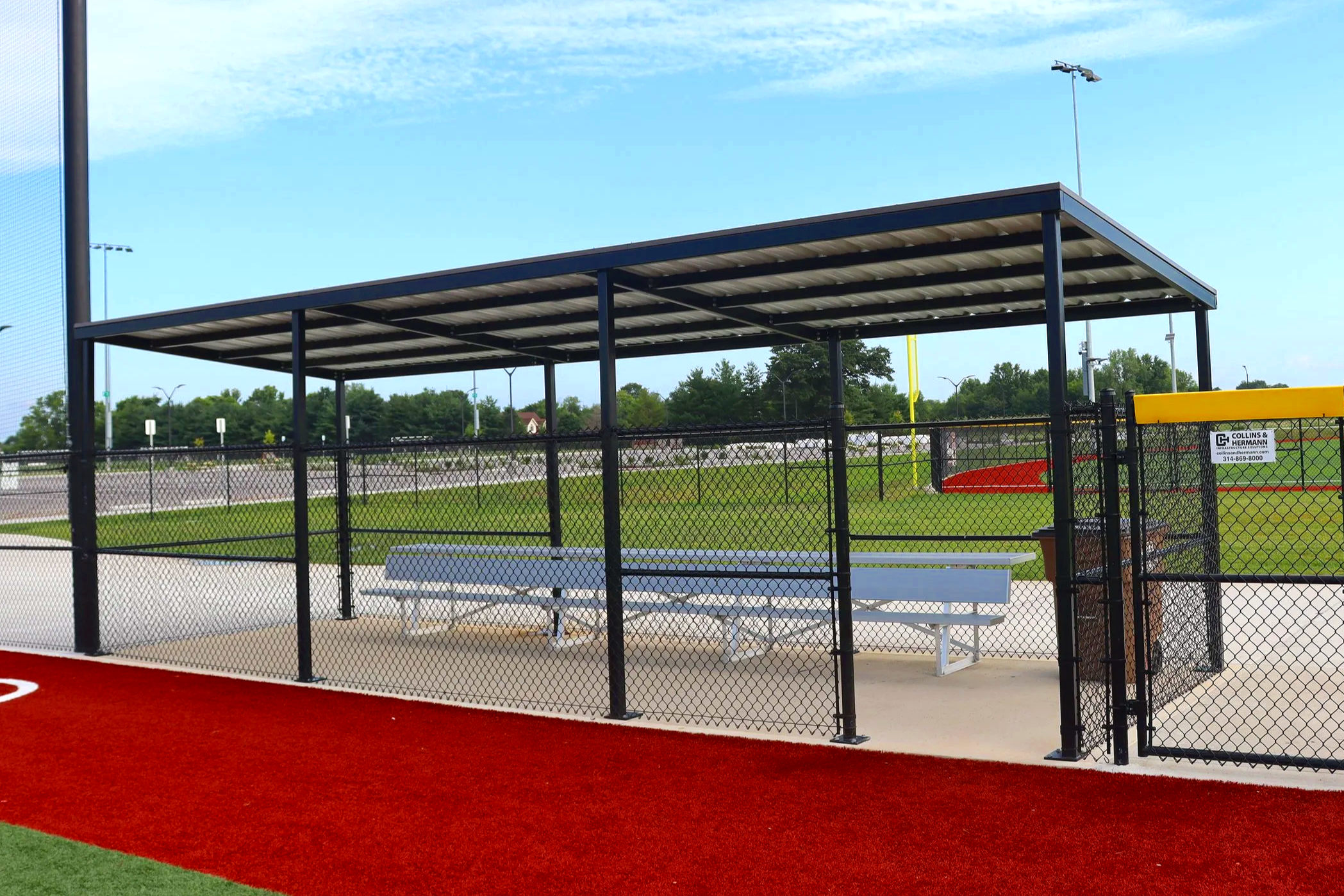 Professional baseball dugout with bench seating on synthetic turf baseball field — USS baseball dugout supplier