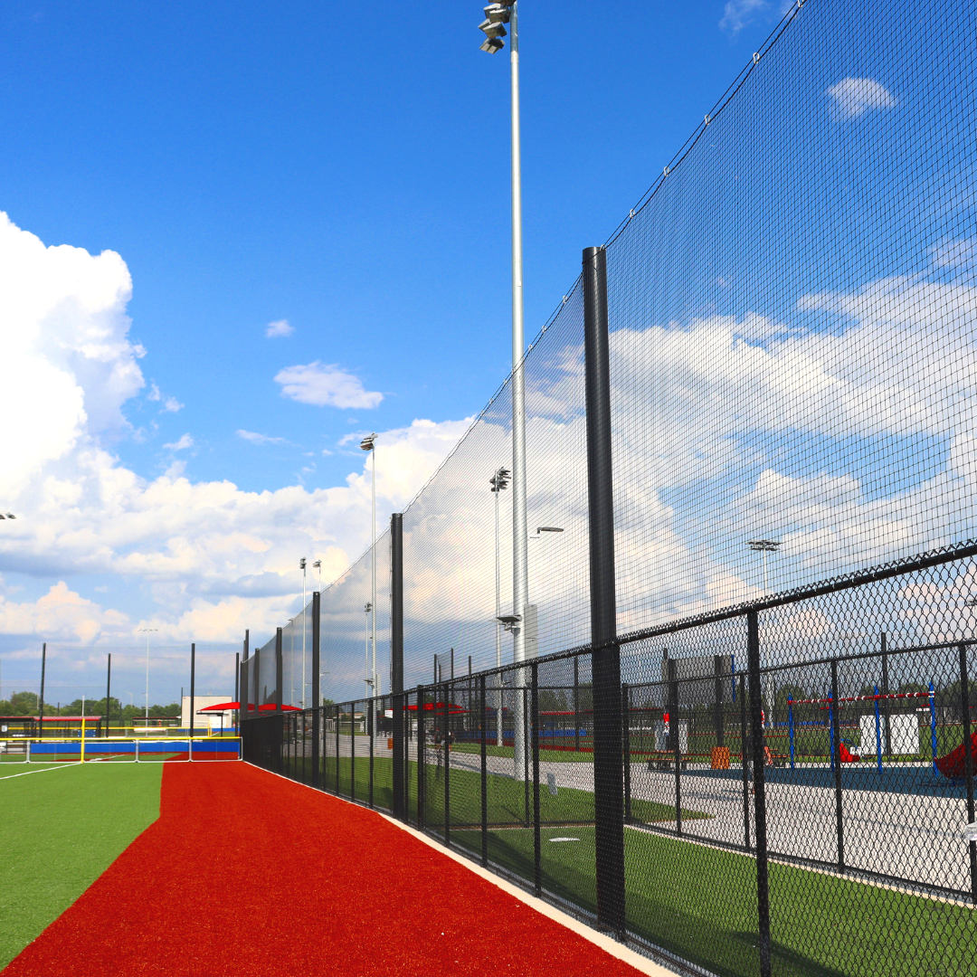 Tall containment netting and chain link fencing at multi-diamond baseball complex in New Lenox IL