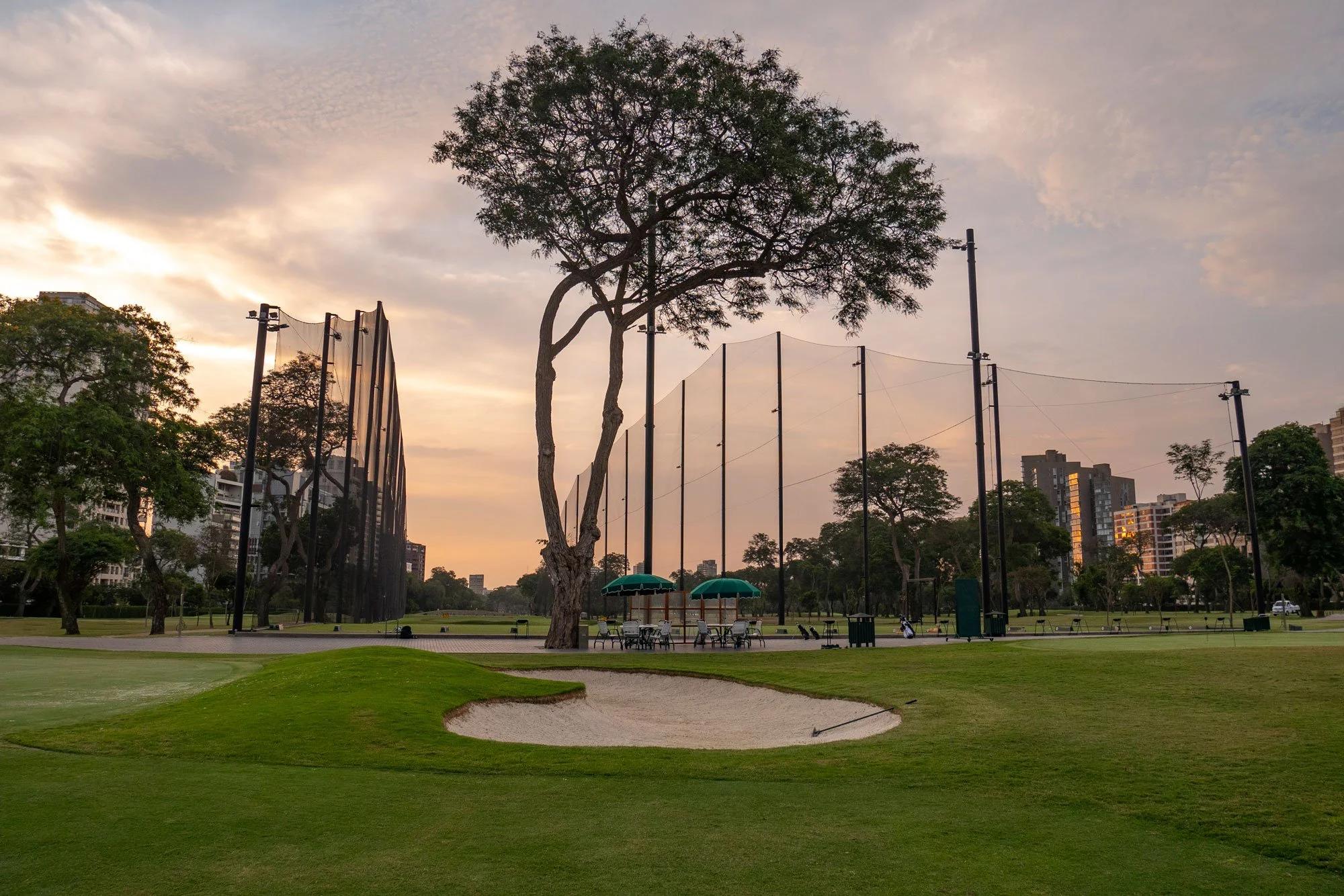 Golf driving range netting system with tall containment poles at athletic facility in Lima Peru