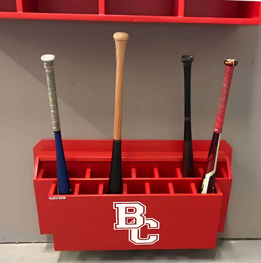 Custom red branded dugout bat rack with team logo installed in baseball dugout interior