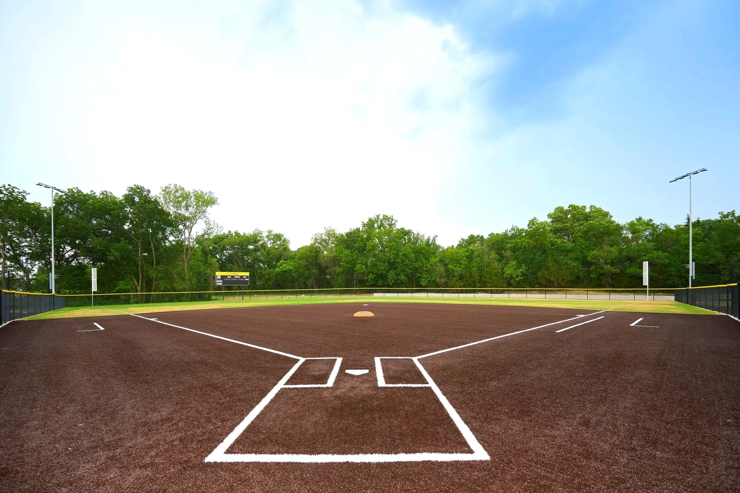 Portable pitching mound on natural dirt infield at CBBA baseball academy — USS portable pitching mound supplier