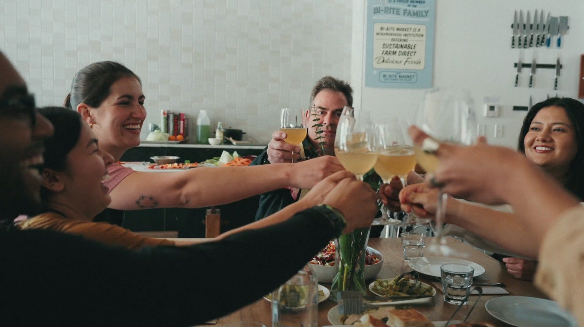 People toasting around a table at 18 reasons non-profit in San Francisco, CA