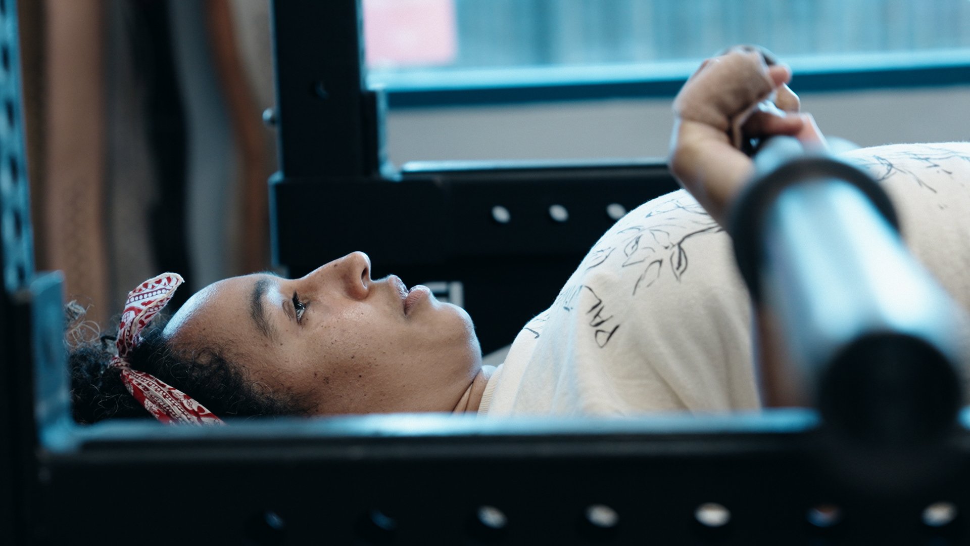 Client performing a bench press at Bay Strength gym in Berkeley, CA
