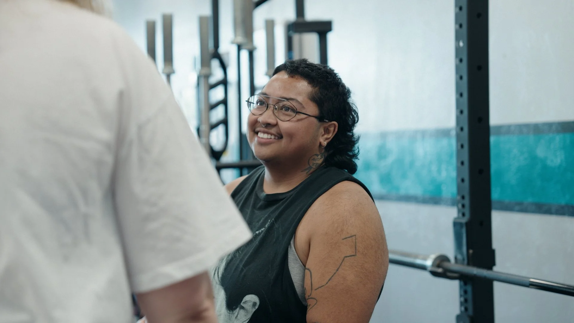 Client talks to a coach at Bay Strength gym in Berkeley, CA