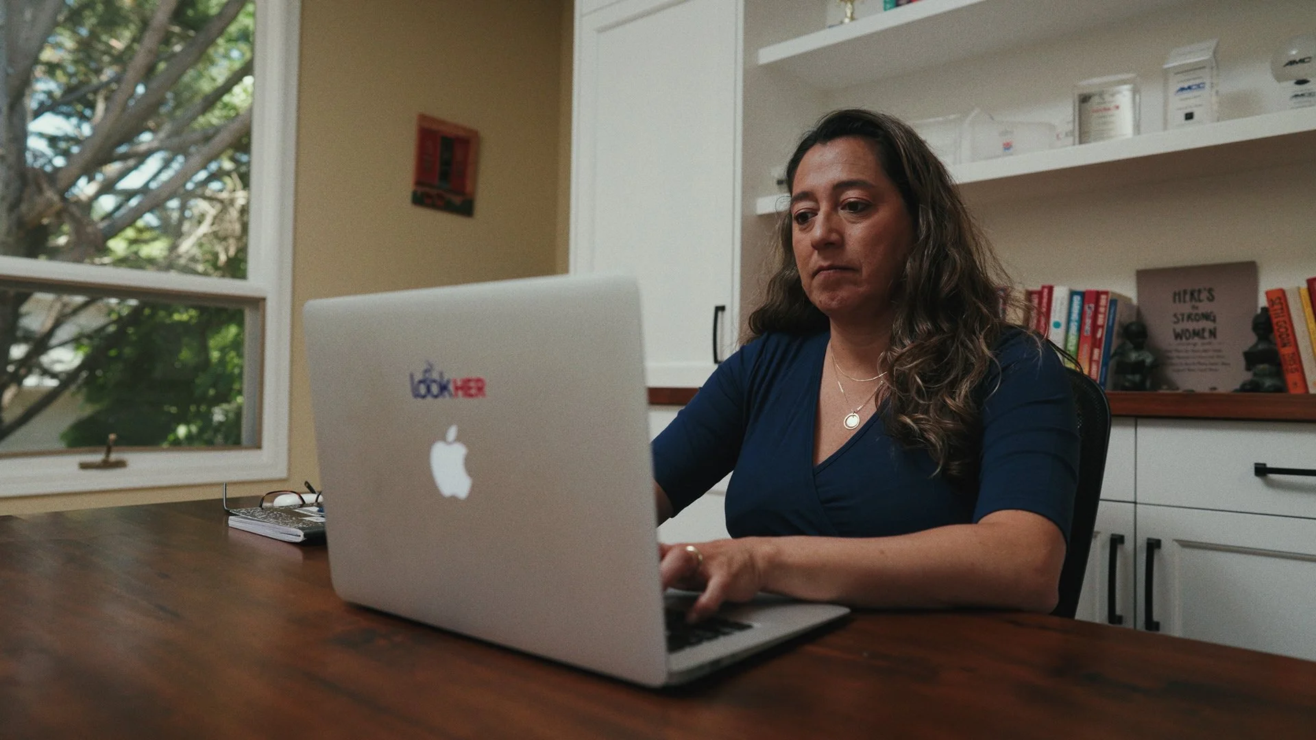 Author Tricia Montalvo typing on computer