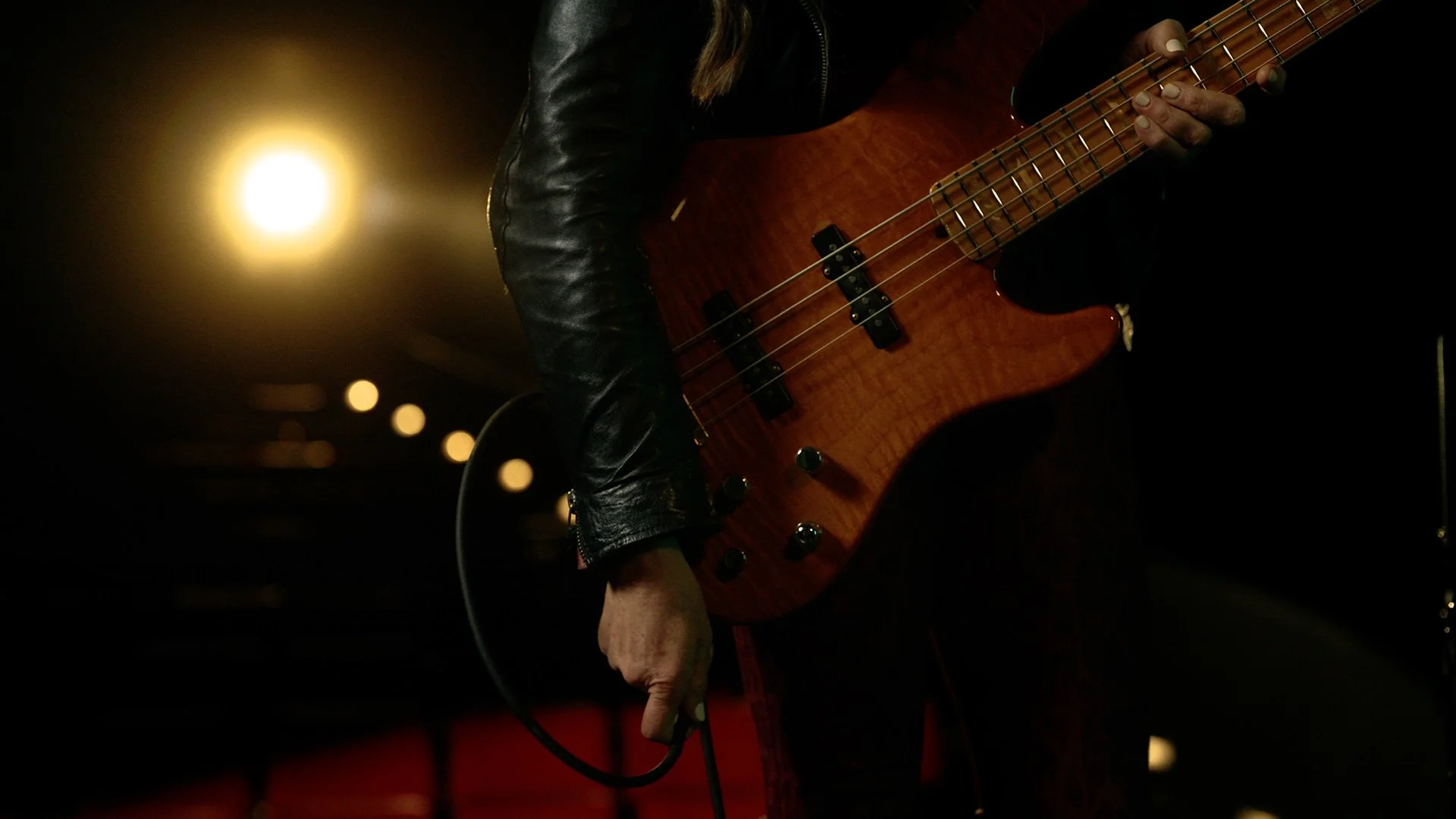 Musician Angeline Saris plugs in bass 