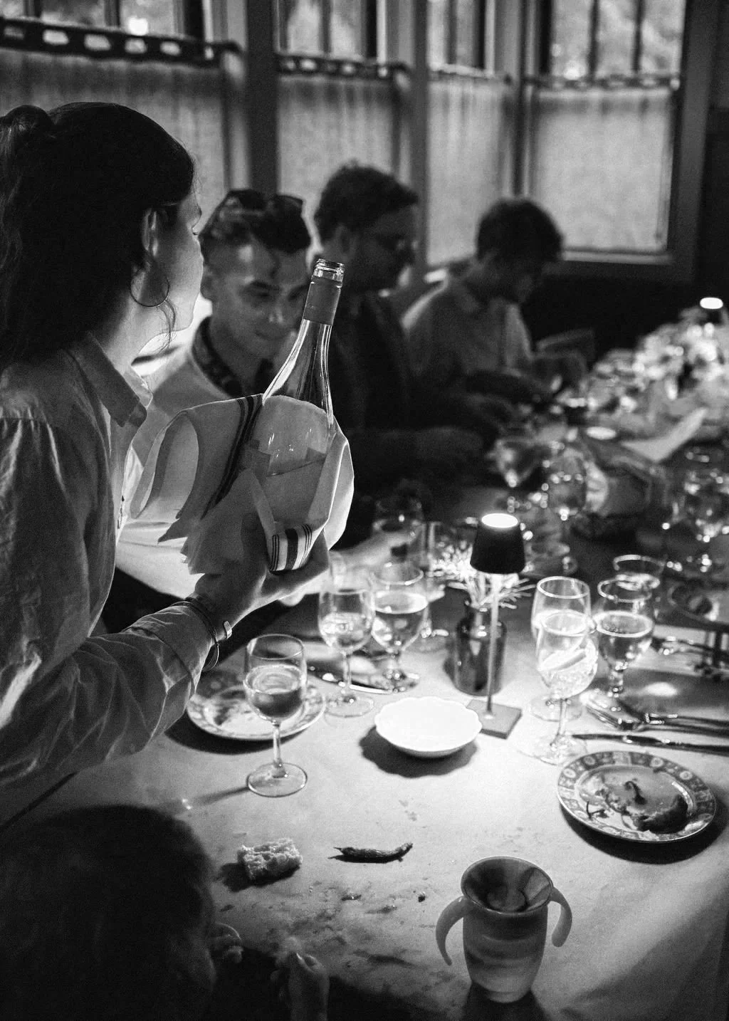 Guests sharing dinner and wine at The Tavern at Liberty Farms