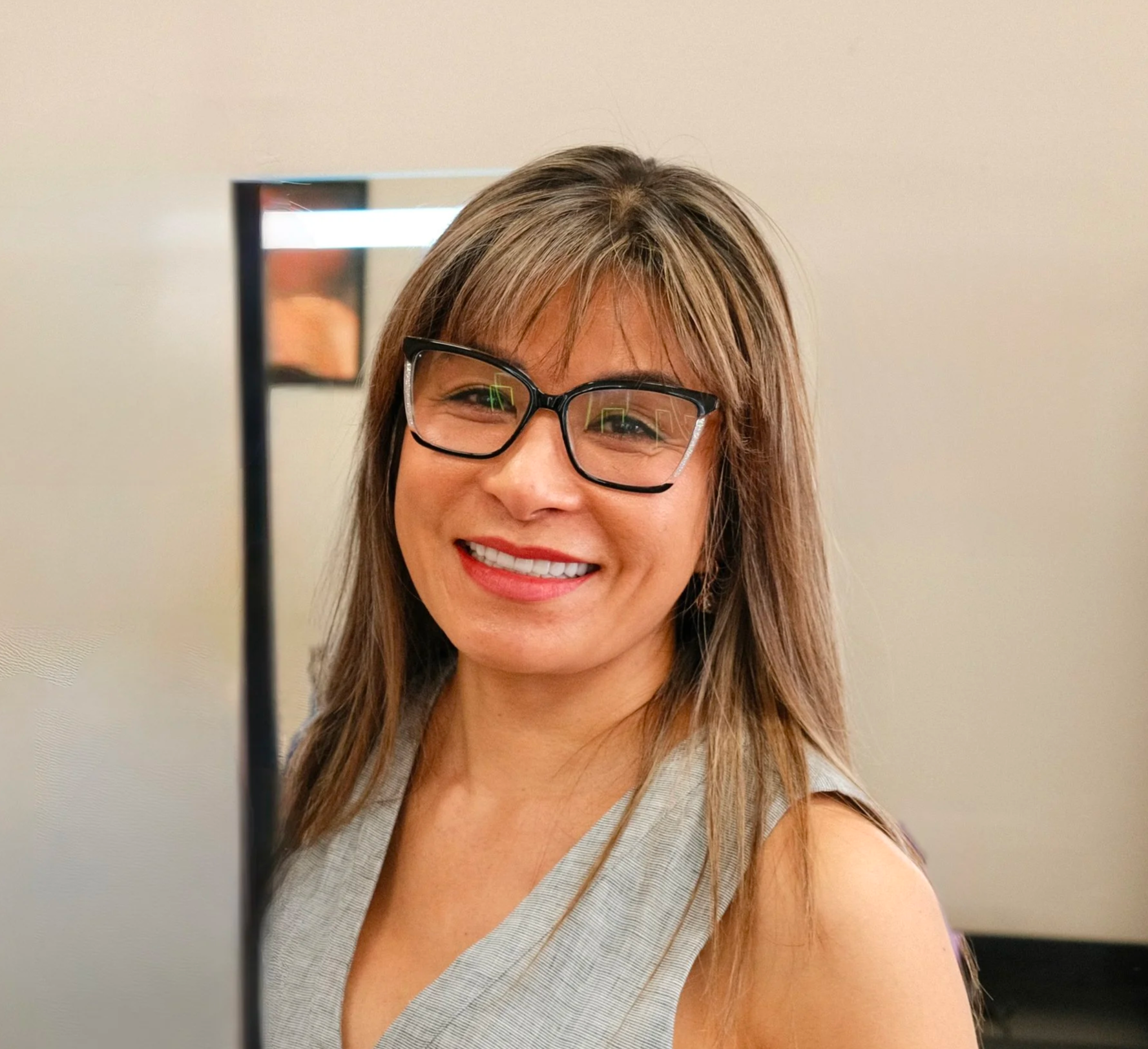 A smiling woman with shoulder-length hair 