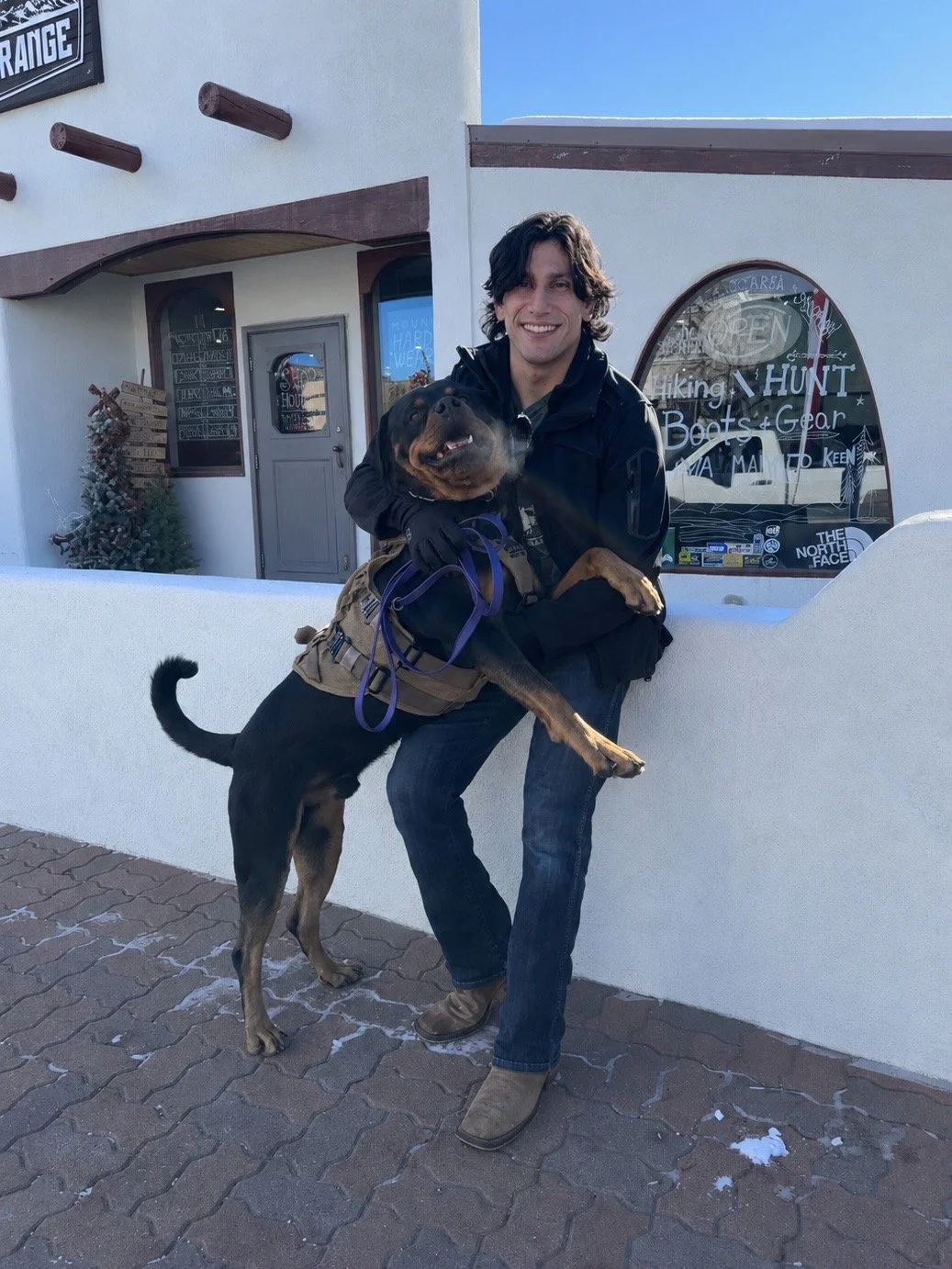 A man with a fun happy big dog, trained and obedient