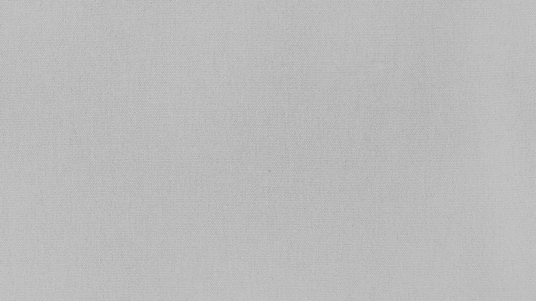 Plain textured light gray fabric surface.