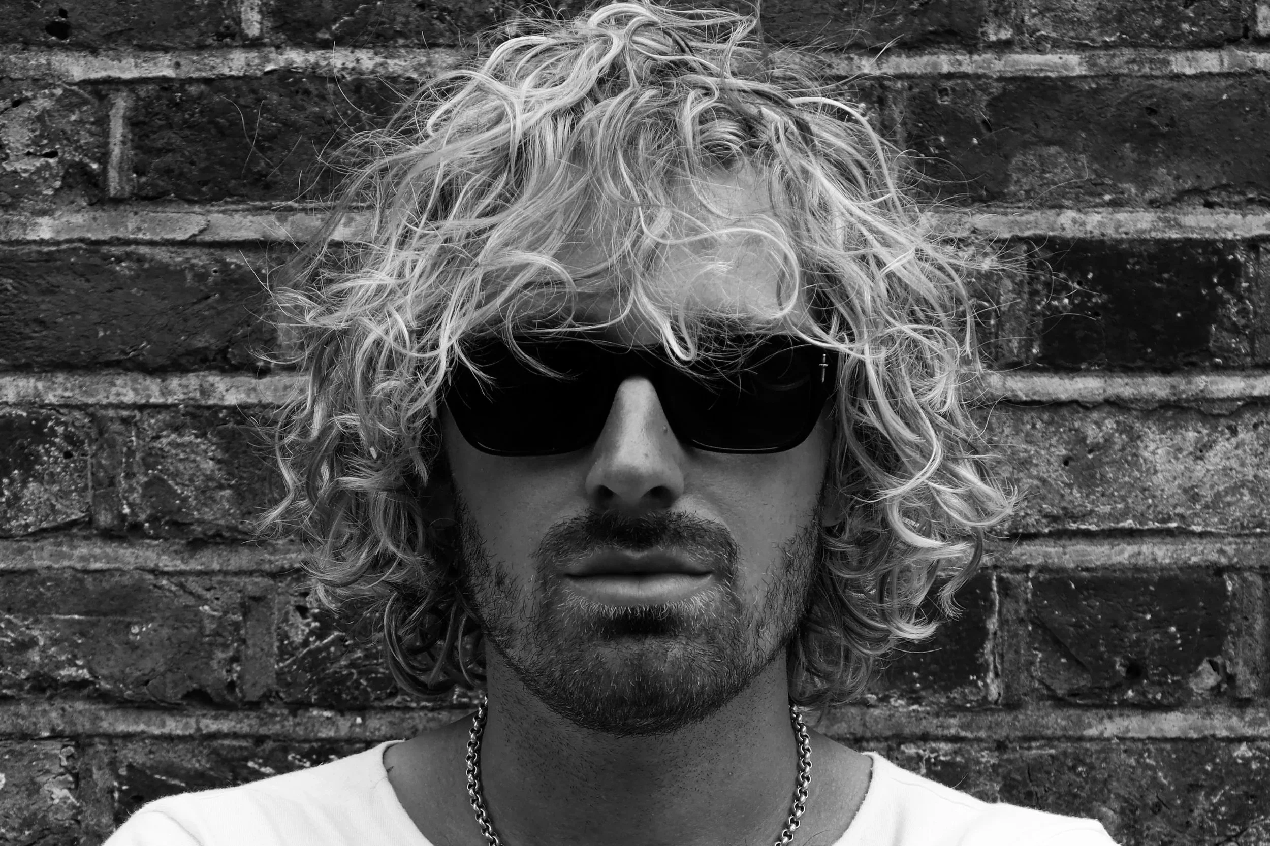 A b&w headshot of drummer James Compton