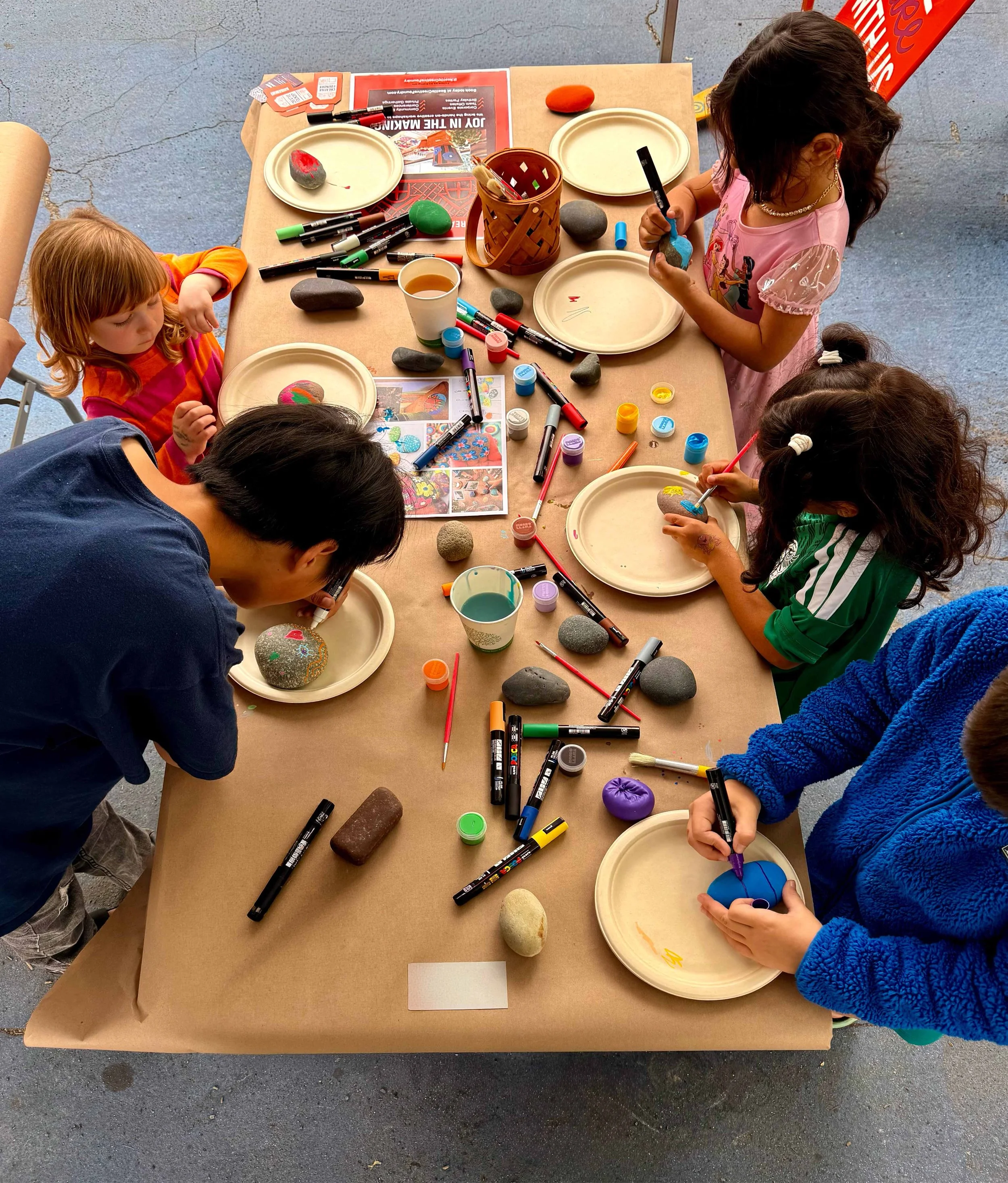 Kids painting rocks with paint markers