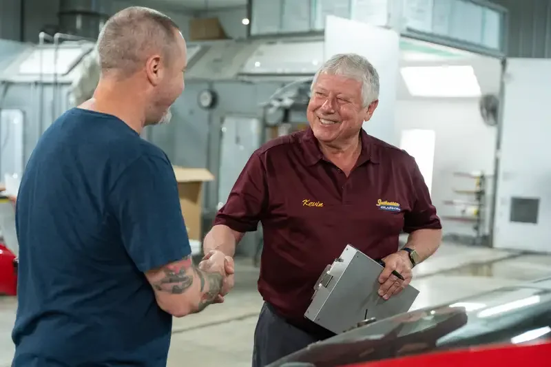 Kevin, owner of Southeastern Glass Co., and Travis, long-time customer, shake hands after a job well done.
