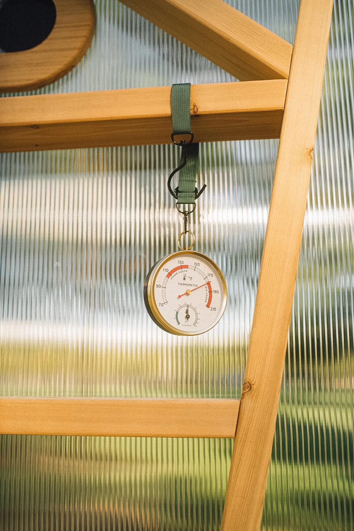 Image of a wood-fired sauna zoomed in on the temperature reading of 180 degrees.