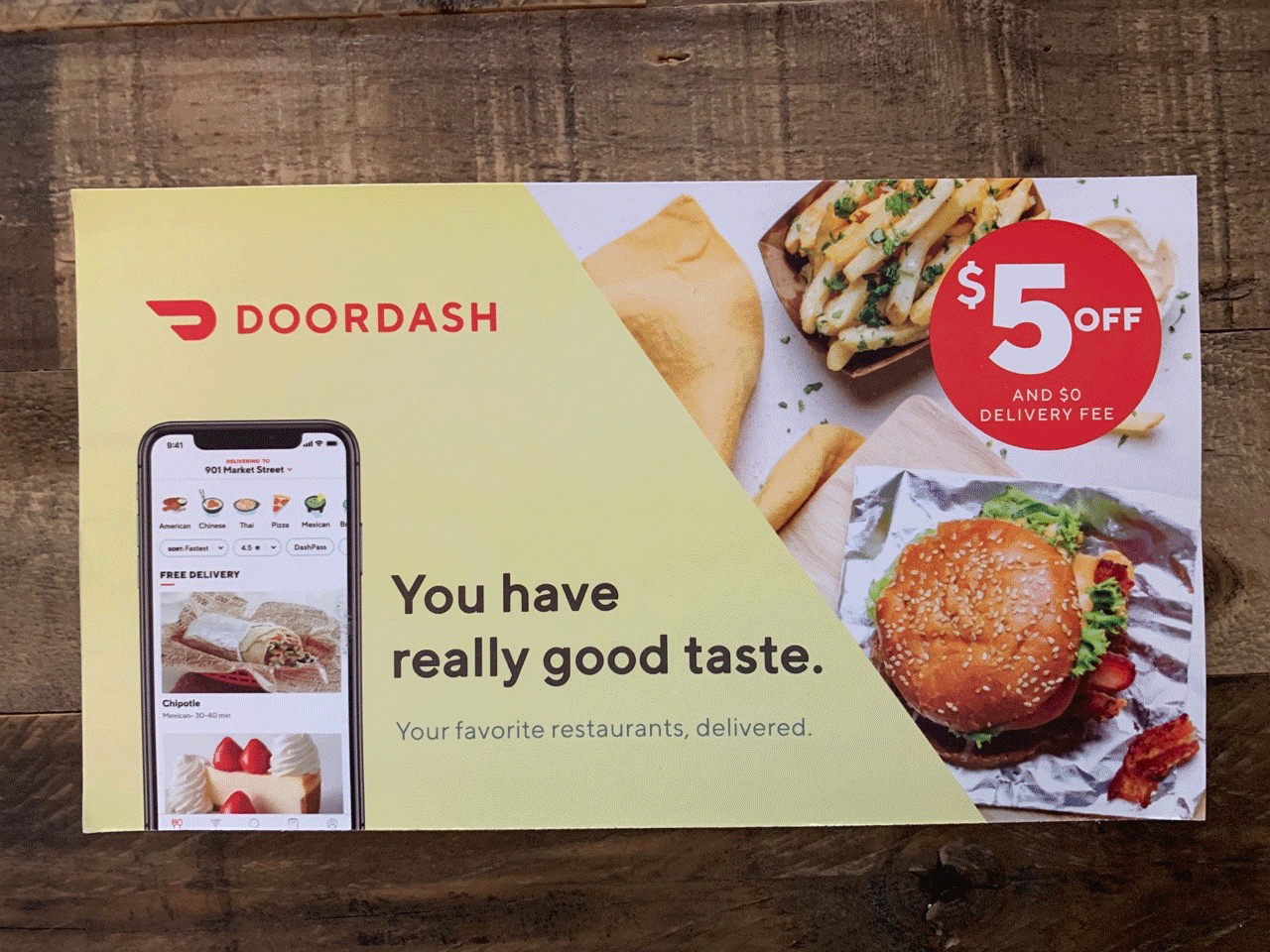 Advertisement for nationally recognized brands featuring images of a burger, fries, and a wrap with a $5 discount offer and free delivery.