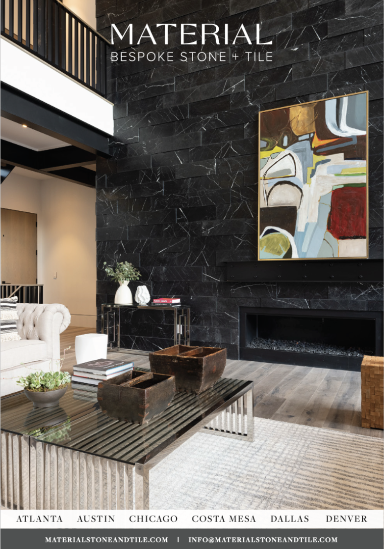Modern living room with a black marble accent wall, colorful abstract painting, white sofa, glass coffee table with decorative boxes, and light wood flooring.