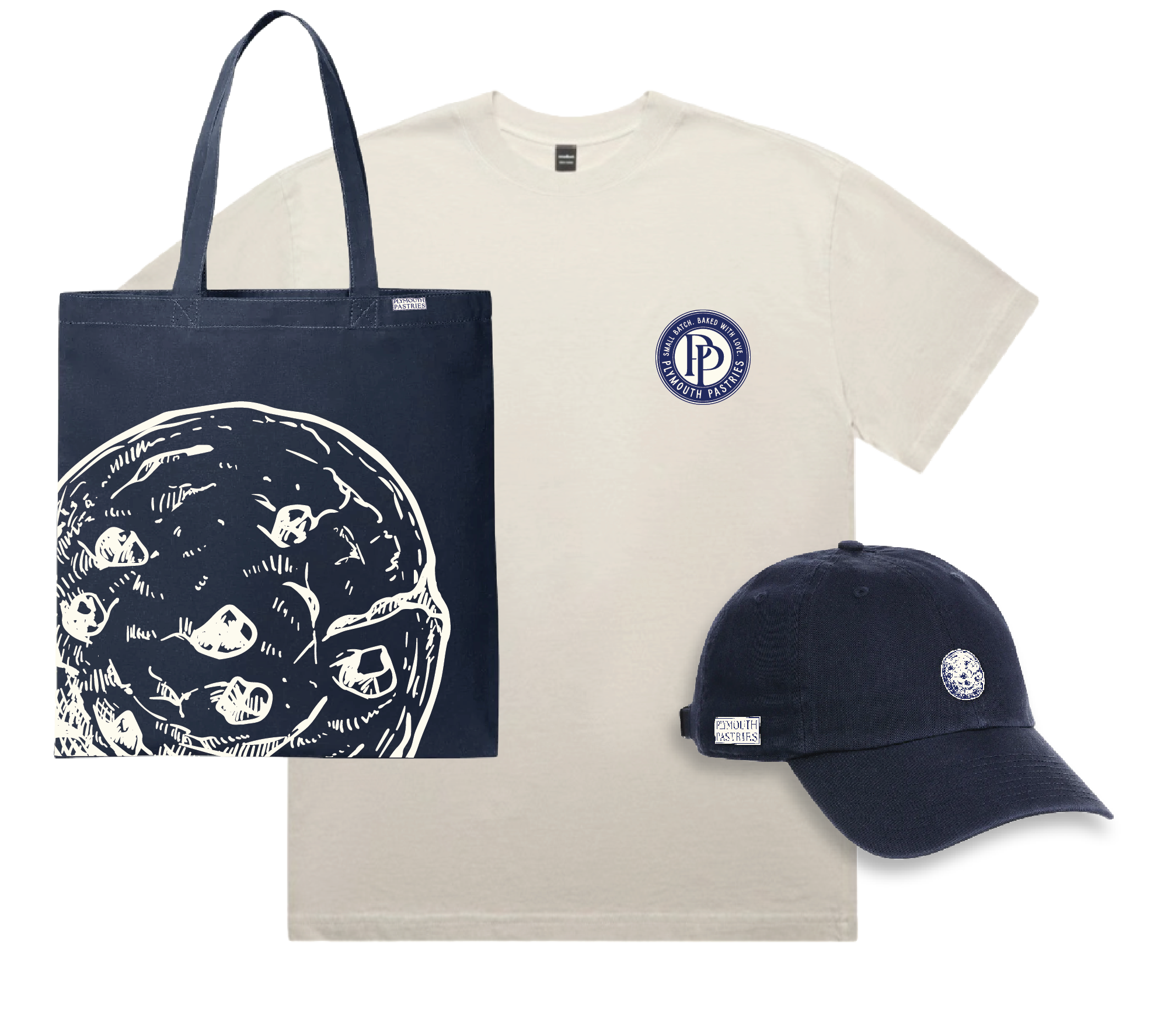 A black tote bag with white screen print. A beige T-shirt with a blue circular logo that reads 'Small Batch Baked with Love' and features a house. A navy blue cap with an image of the moon. The items are branded with a label reading 'Plymouth Pastries'.