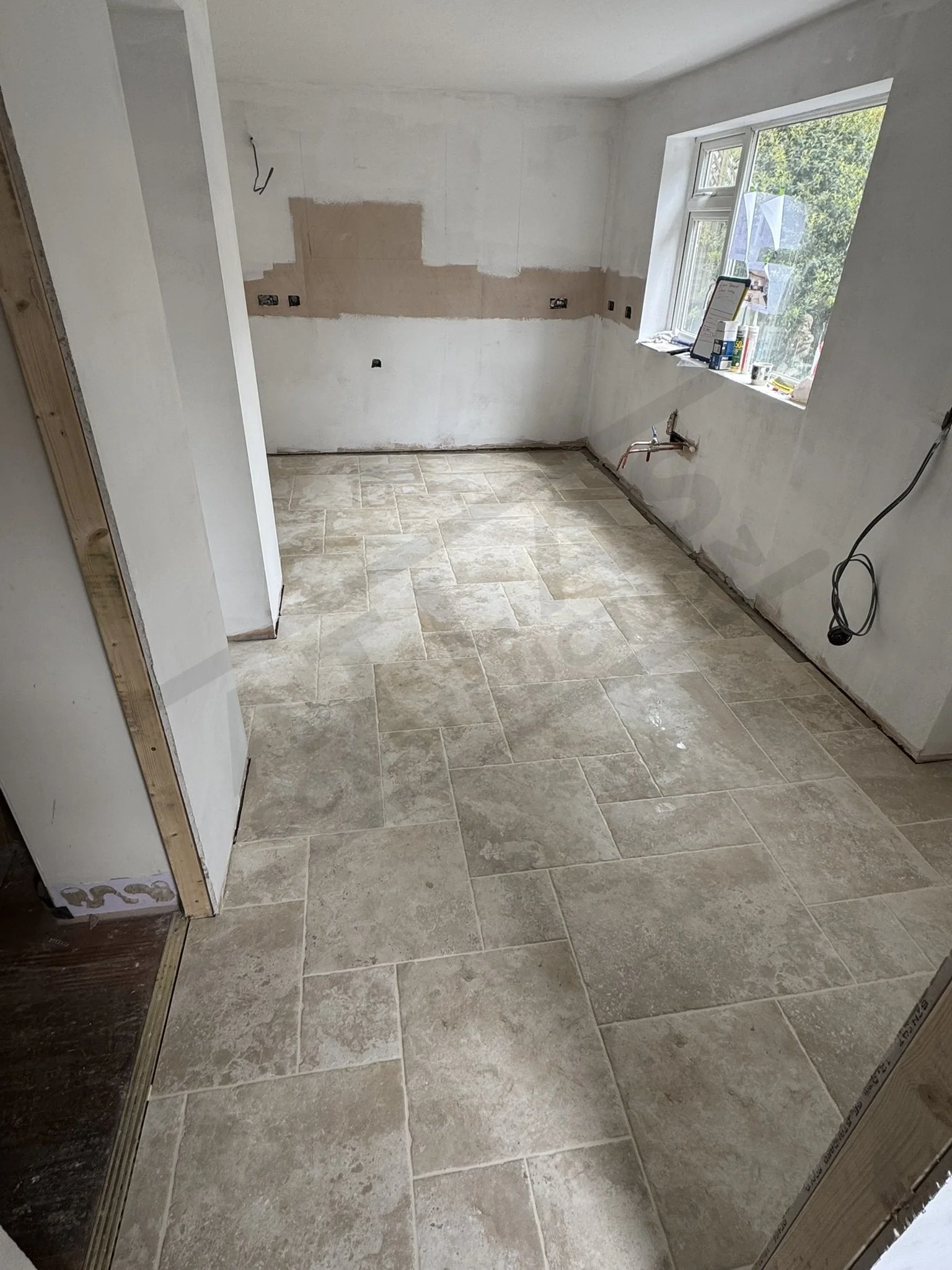 Tiled floor ready for kitchen installation