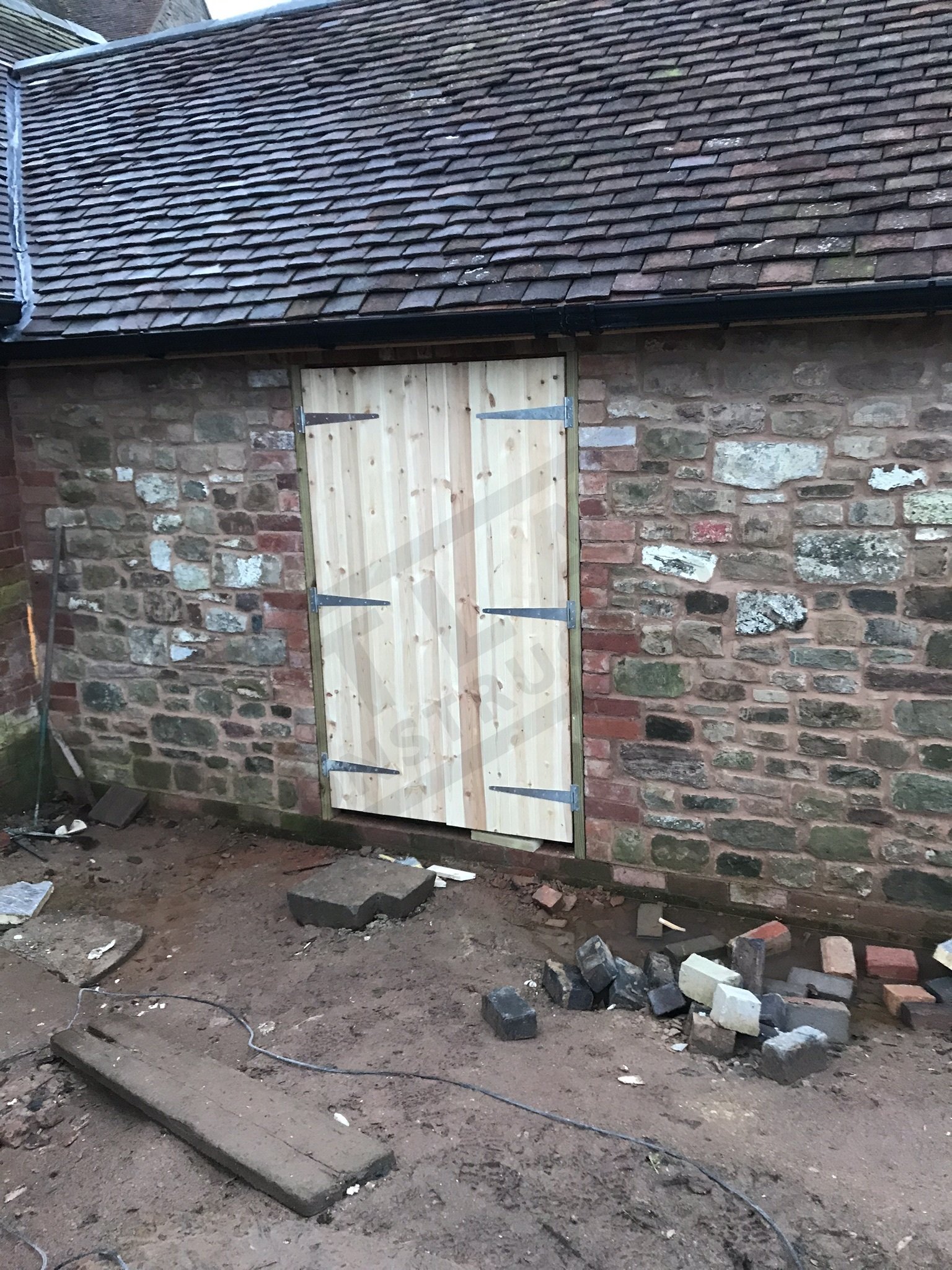 Newbuild stone extension with bespoke door shutters