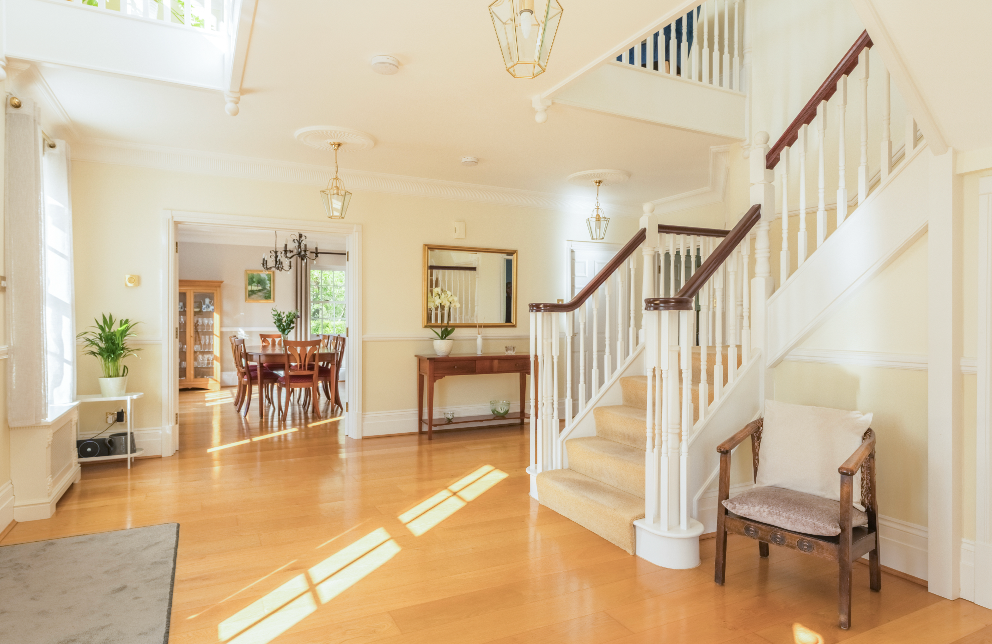 A bright stylish interior entrance hall with a staircase.