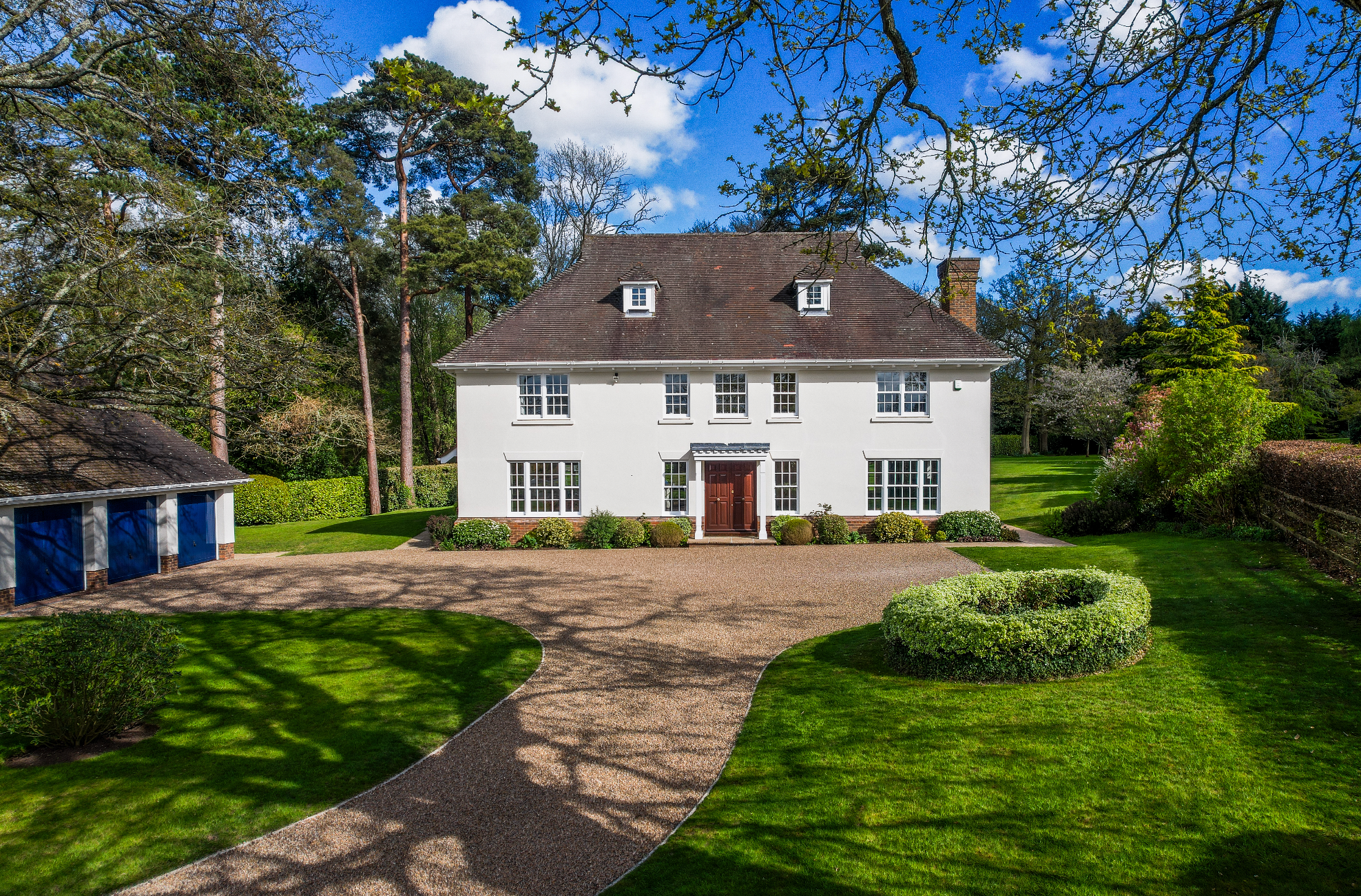 Large beautiful white house with triple garage.