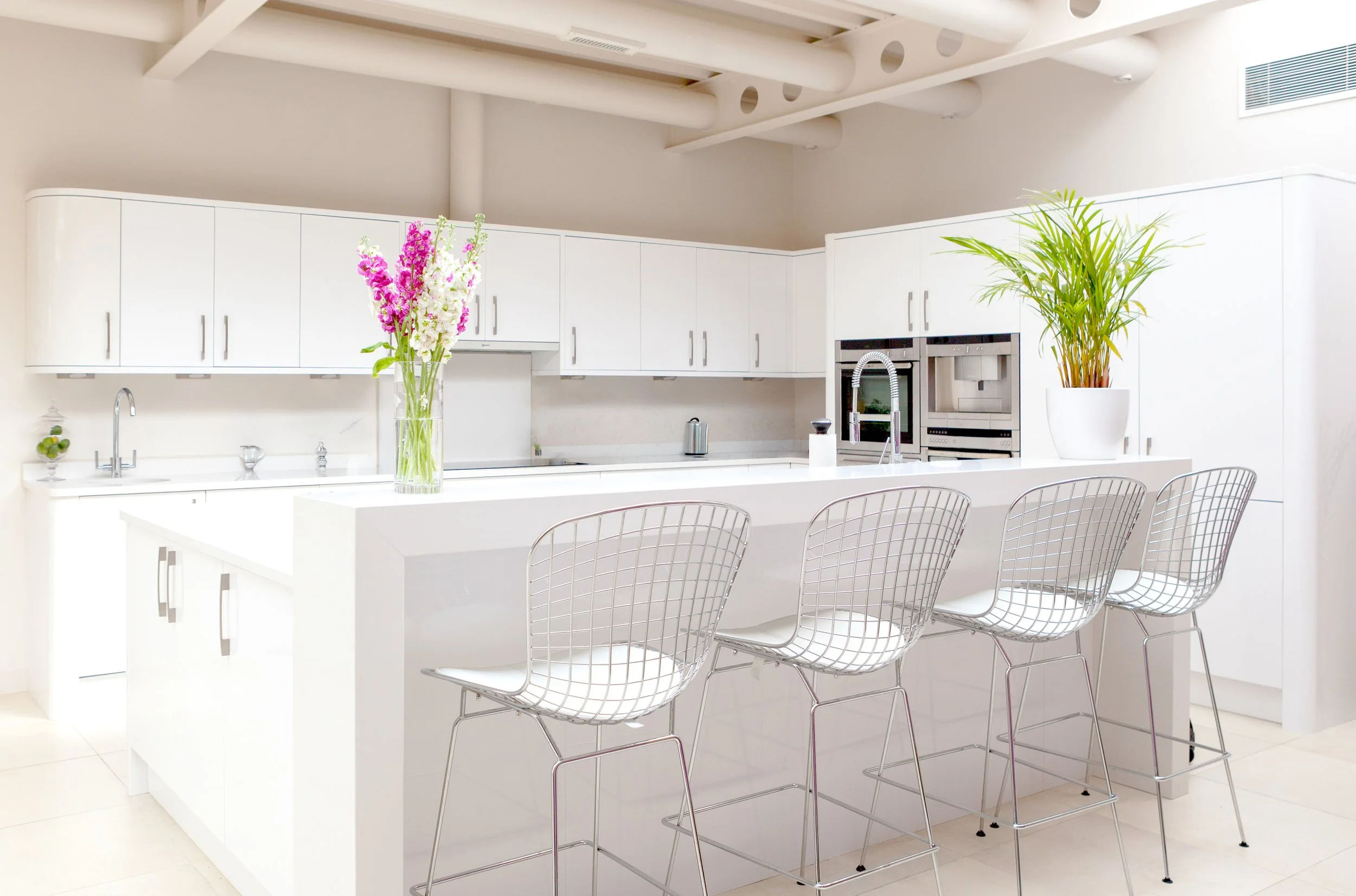 Interior design photography of a contemporary white kitchen.