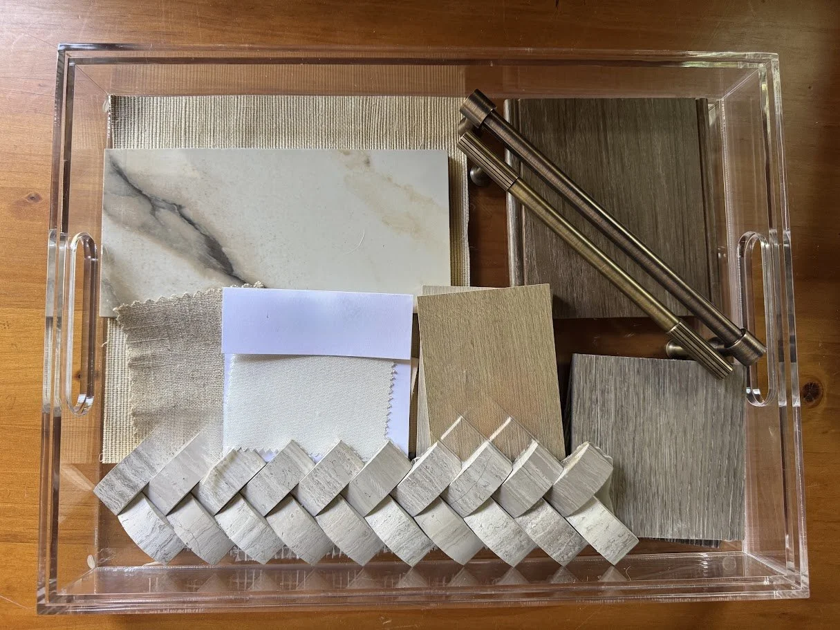 Sample display of interior design materials including fabric swatches, tile samples, and wood veneer pieces inside a clear acrylic container.