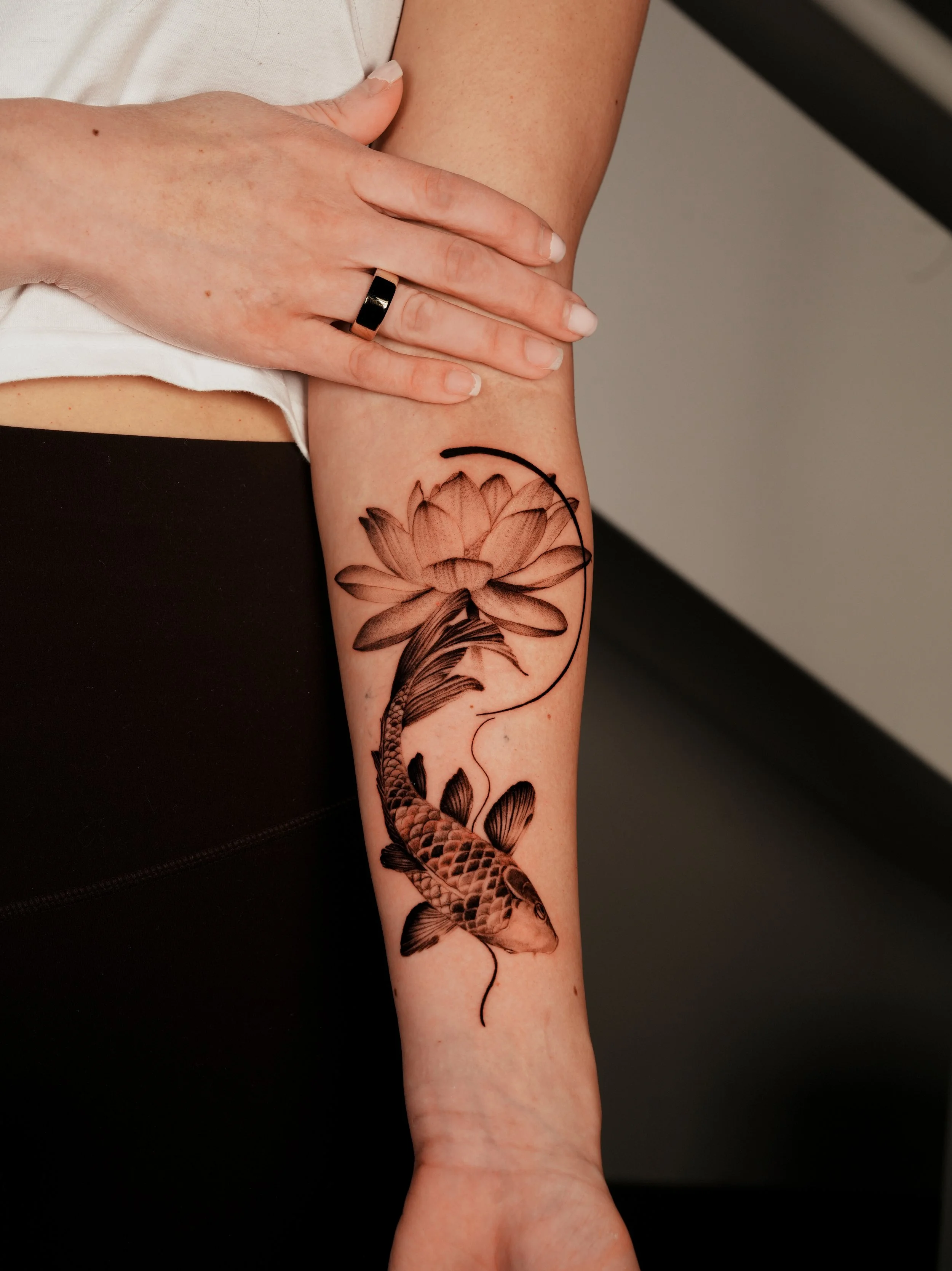 Micro-Realism and Floral tattoo of Koi Fish and Lotus Flower on the forearm