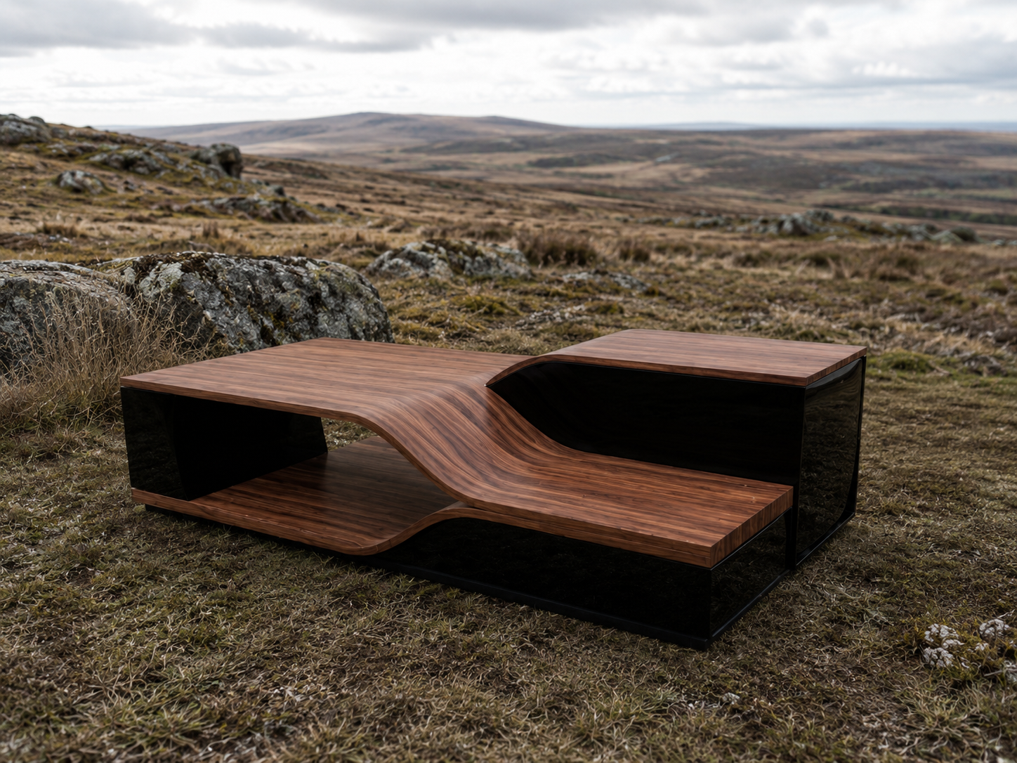 Contemporary wooden and black metal outdoor bench in a grassy field with rocks and rolling hills under cloudy sky.