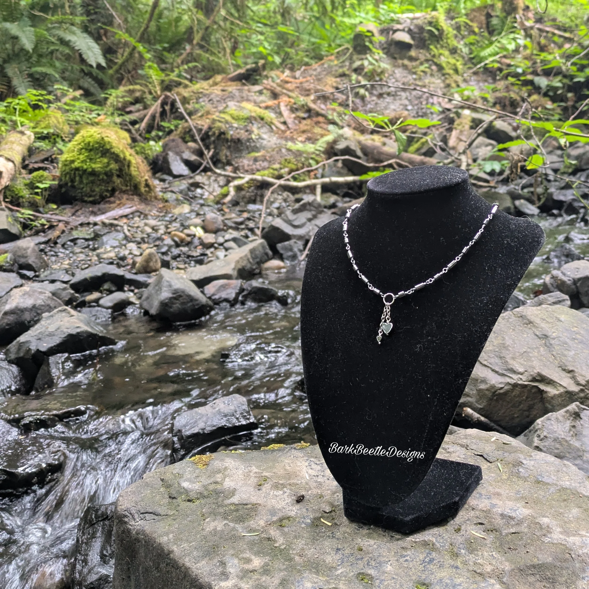 Handmade necklace using cylindrical and heart-shaped hematite beads