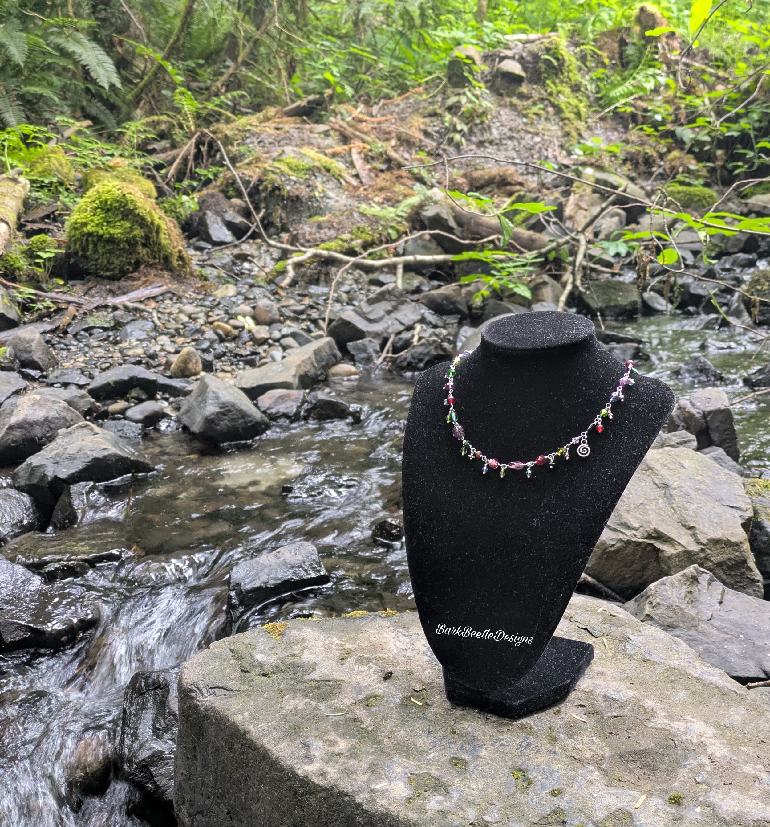 Handmade necklace using acrylic and glass beads with a jewel tones color scheme