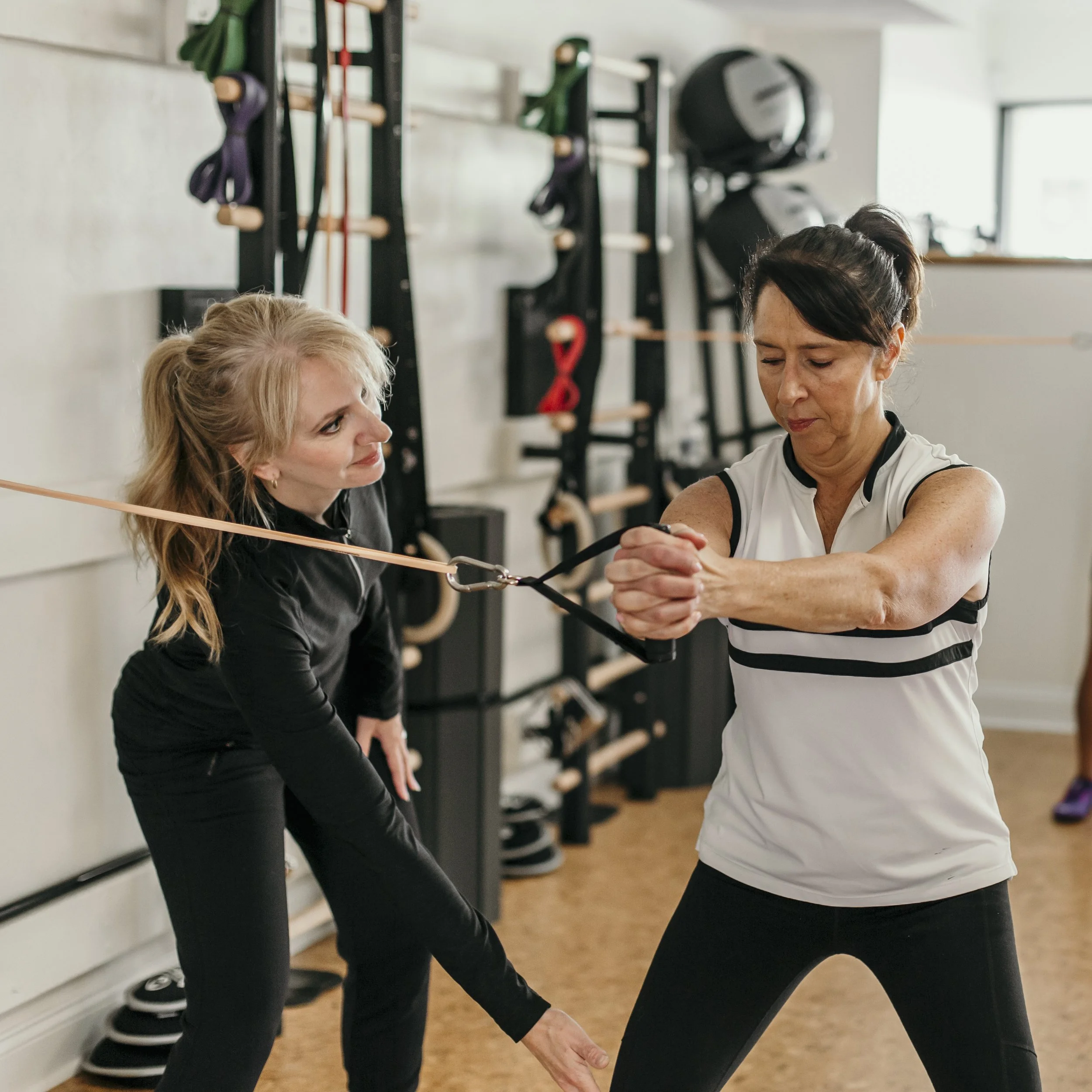 Personal trainer coaching a woman over 50 during a strength training session at A50 Personal Training